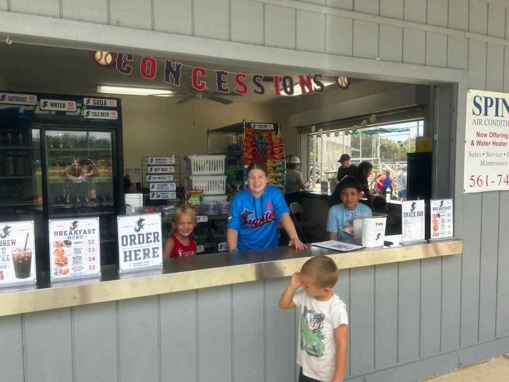 Jupiter Hammerheads players’ siblings helping at the concession stand at Jupiter Community Park during Labor Day weekend.