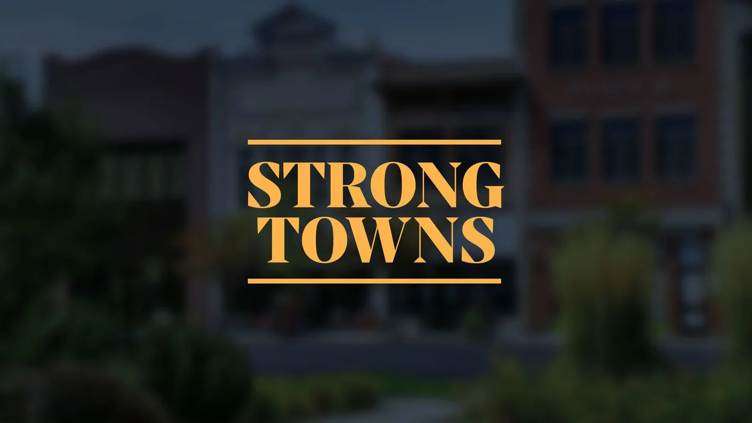 Title screen with the words 'Strong Towns' in orange text on a blurred background of urban houses.