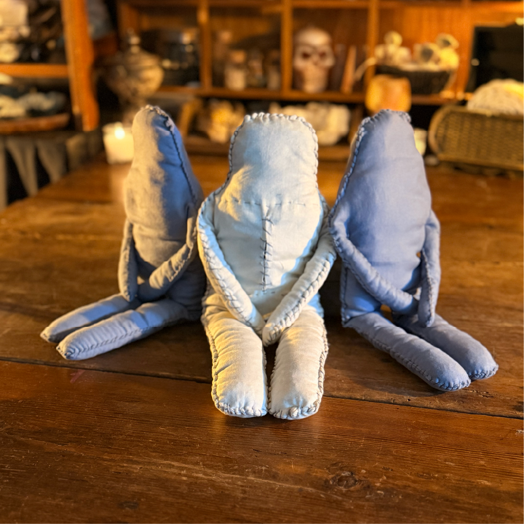 Three handmade cloth ragdoll figures seated together, labeled ‘Ragfolk’”