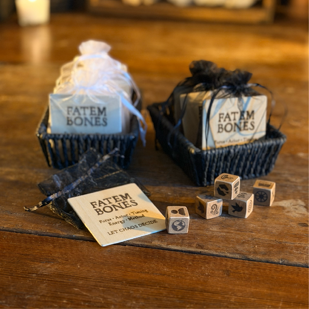 Wood-burned dice and cards labeled ‘Fatem Bones,’ packaged in dark drawstring pouches