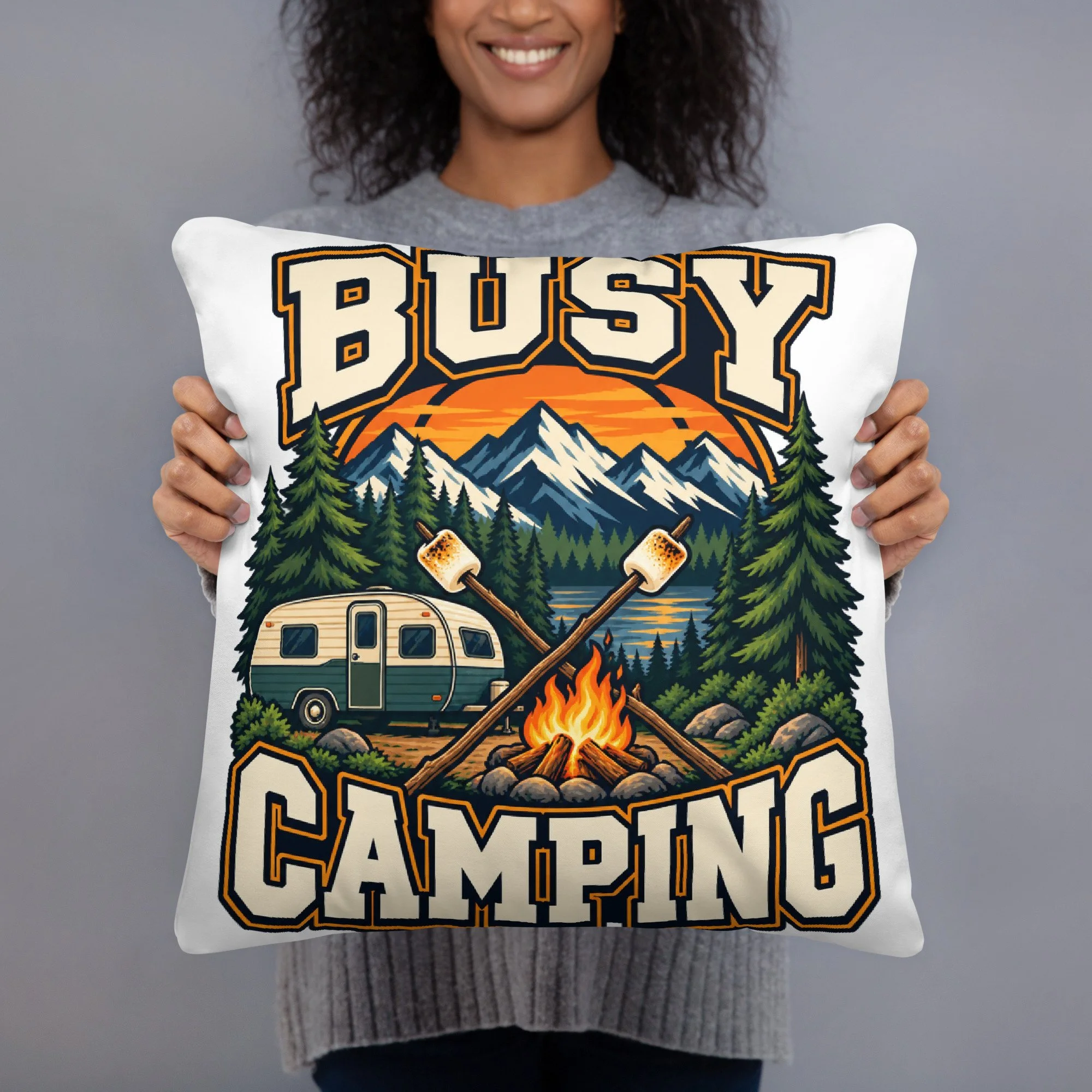 Busy Camping camping throw pillow with vintage camper, mountains and campfire design, 18 by 18 inches, front view