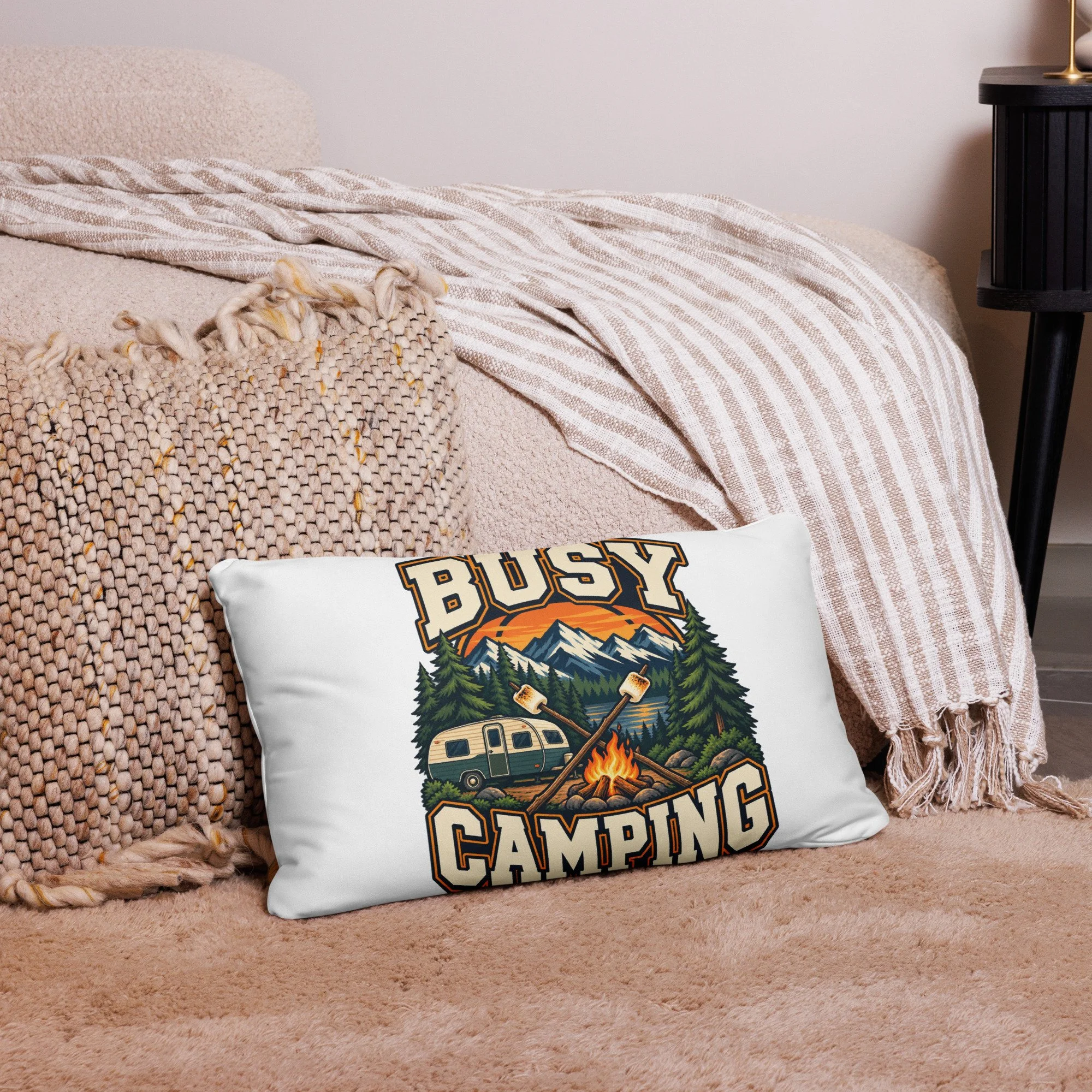 Busy Camping camping throw pillow with vintage camper, mountains and campfire design, 20 by 12 inches, front view