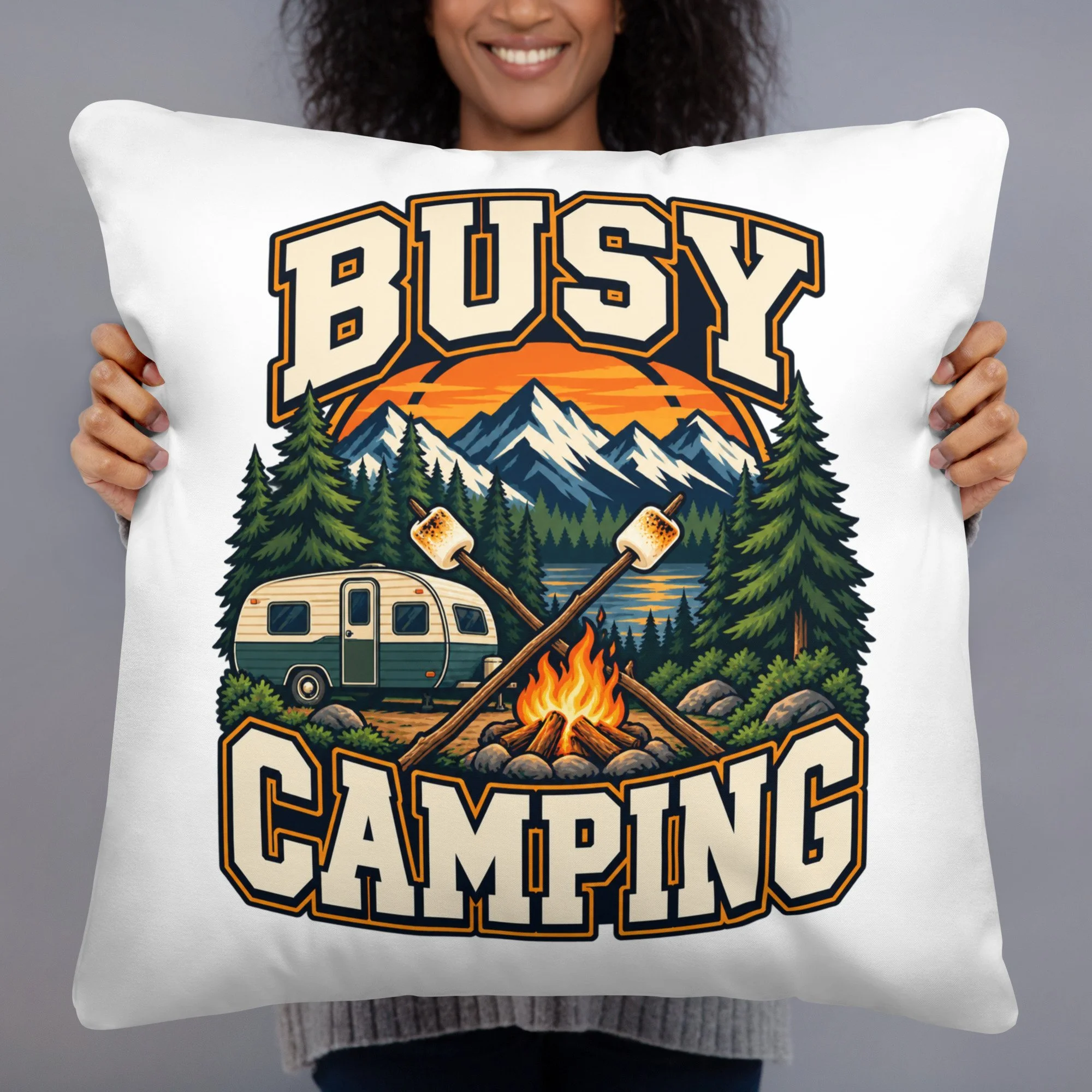 Busy Camping camping throw pillow with vintage camper, mountains and campfire design, 22 by 22 inches, front view