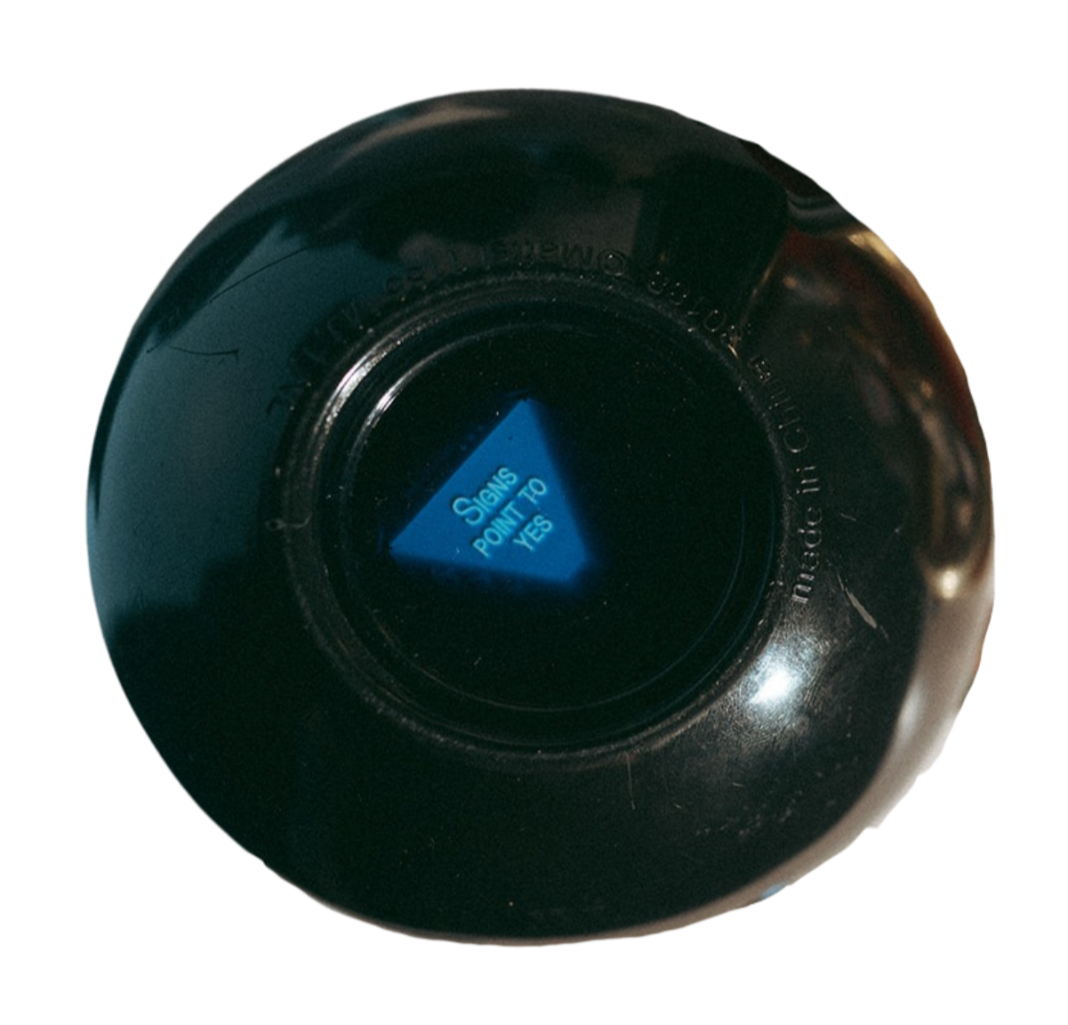 Close-up of a black button with a blue triangle pointing down, labeled 'Signals Point to Yes'.