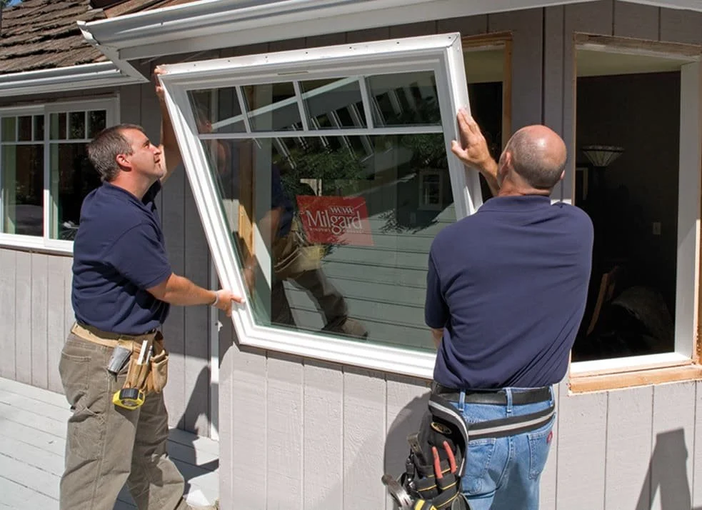 installing a  window on a house exterior.
