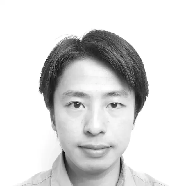 Black and white portrait of a young man with straight hair, wearing a collared shirt.