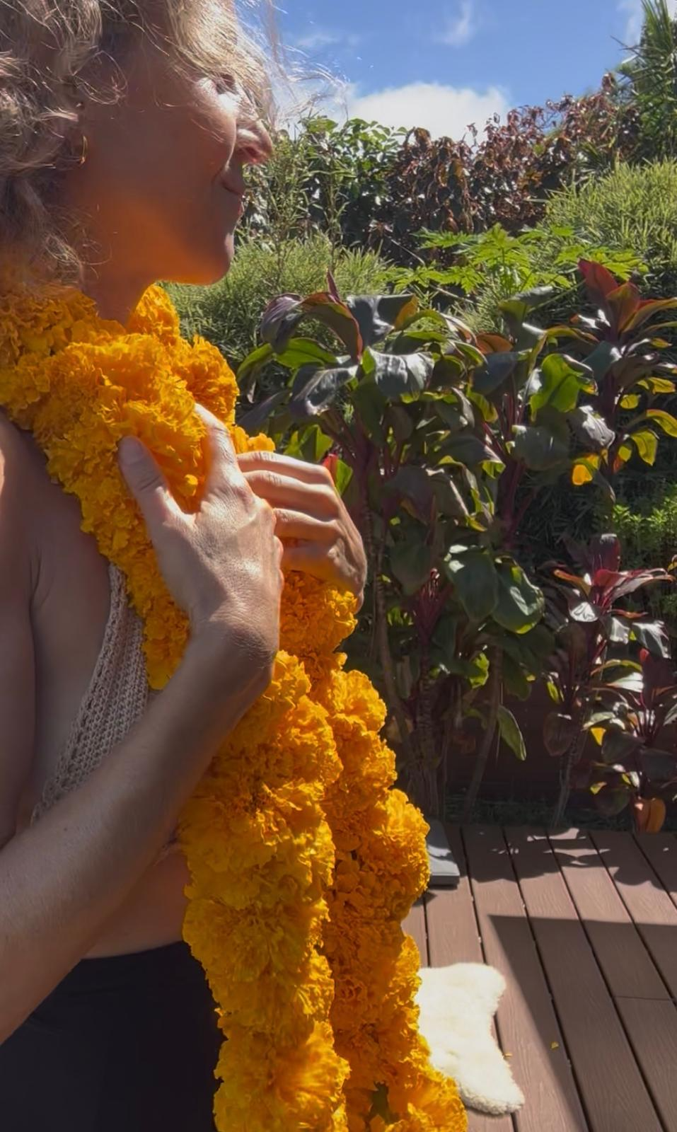Retreat host wearing a handmade Hawaiian lei