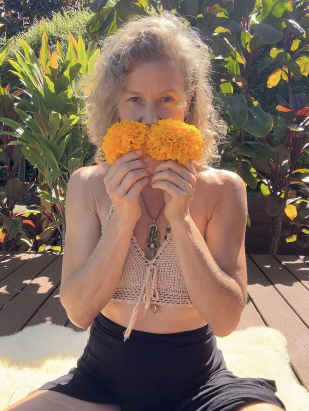 Retreat host smelling fresh tropical flowers in Hawaii