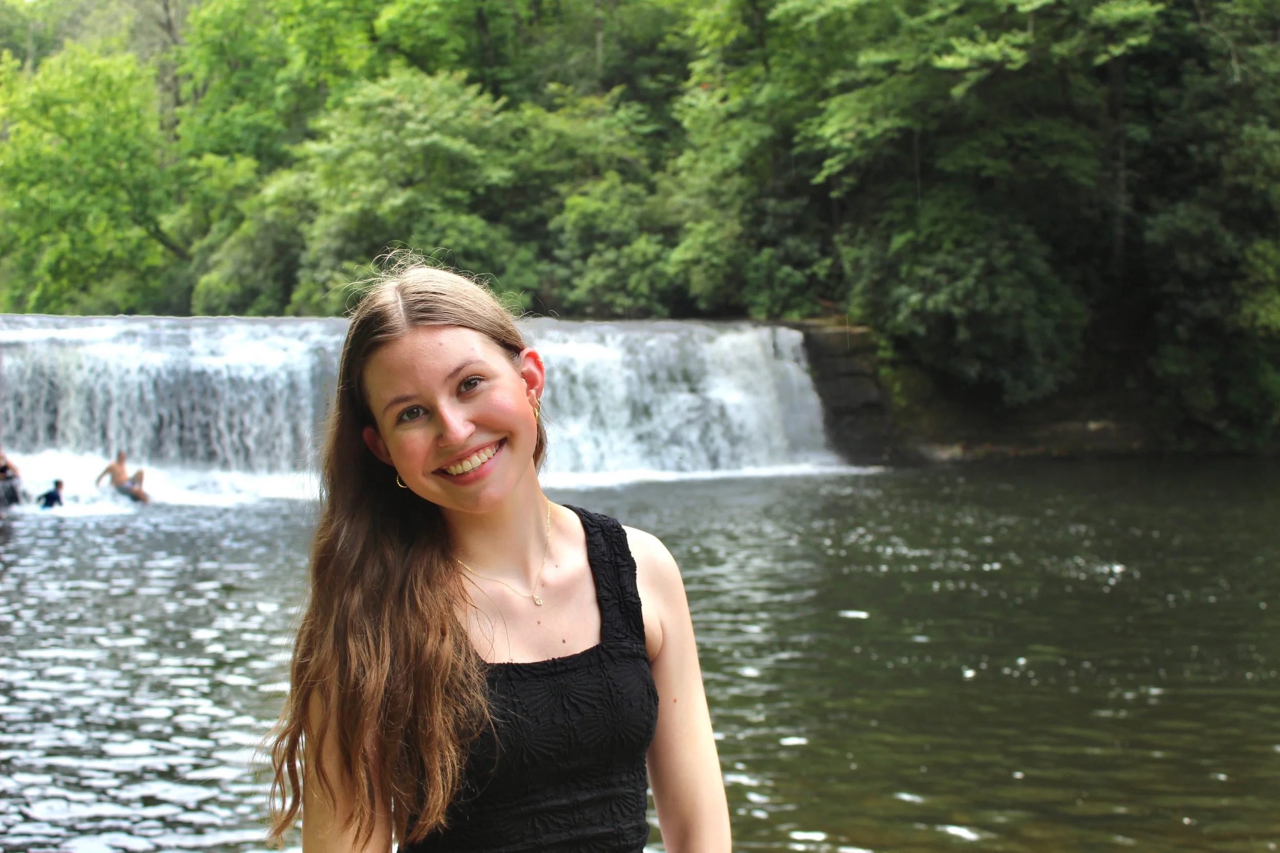 photo of Cheslyn, stylist, with a waterfall in the background