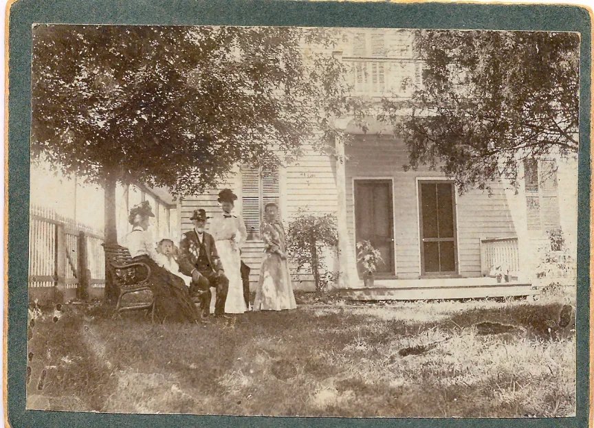 black and white photograph of Nicolas Krekel and his family on the front porch of historic Krekel house in O'Fallon Missouri