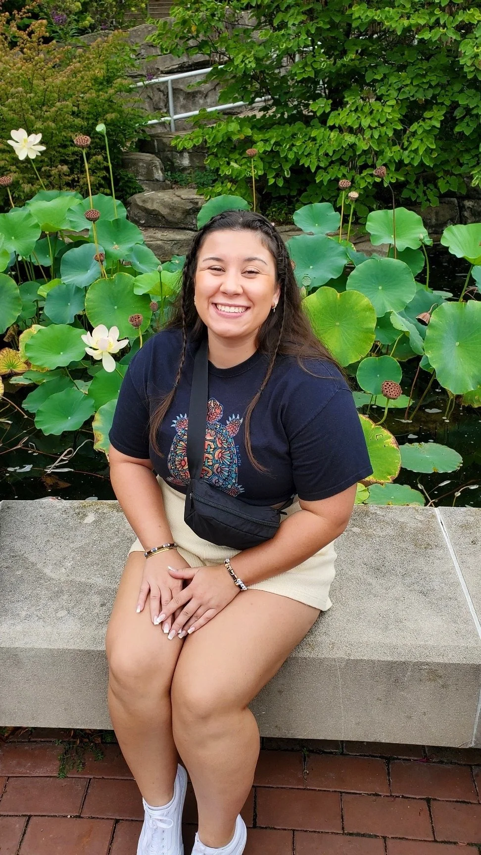 photo of Ashley, stylist, with water lily in the back