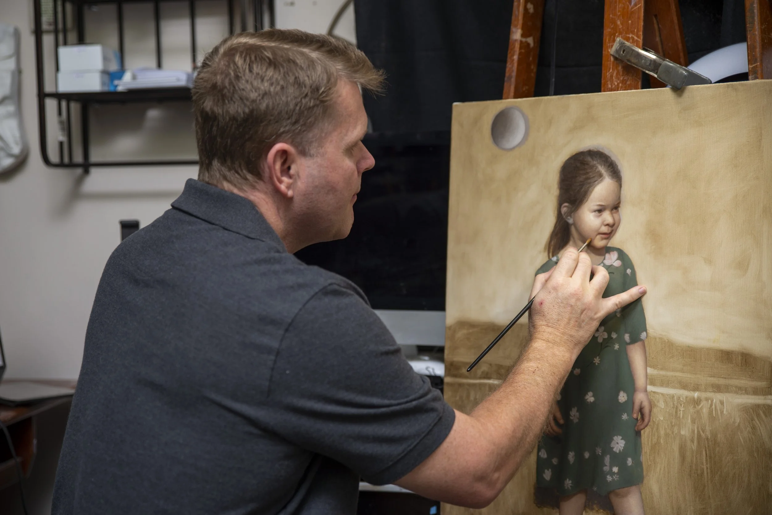 Joe Mattus painting a realistic portrait of a young girl
