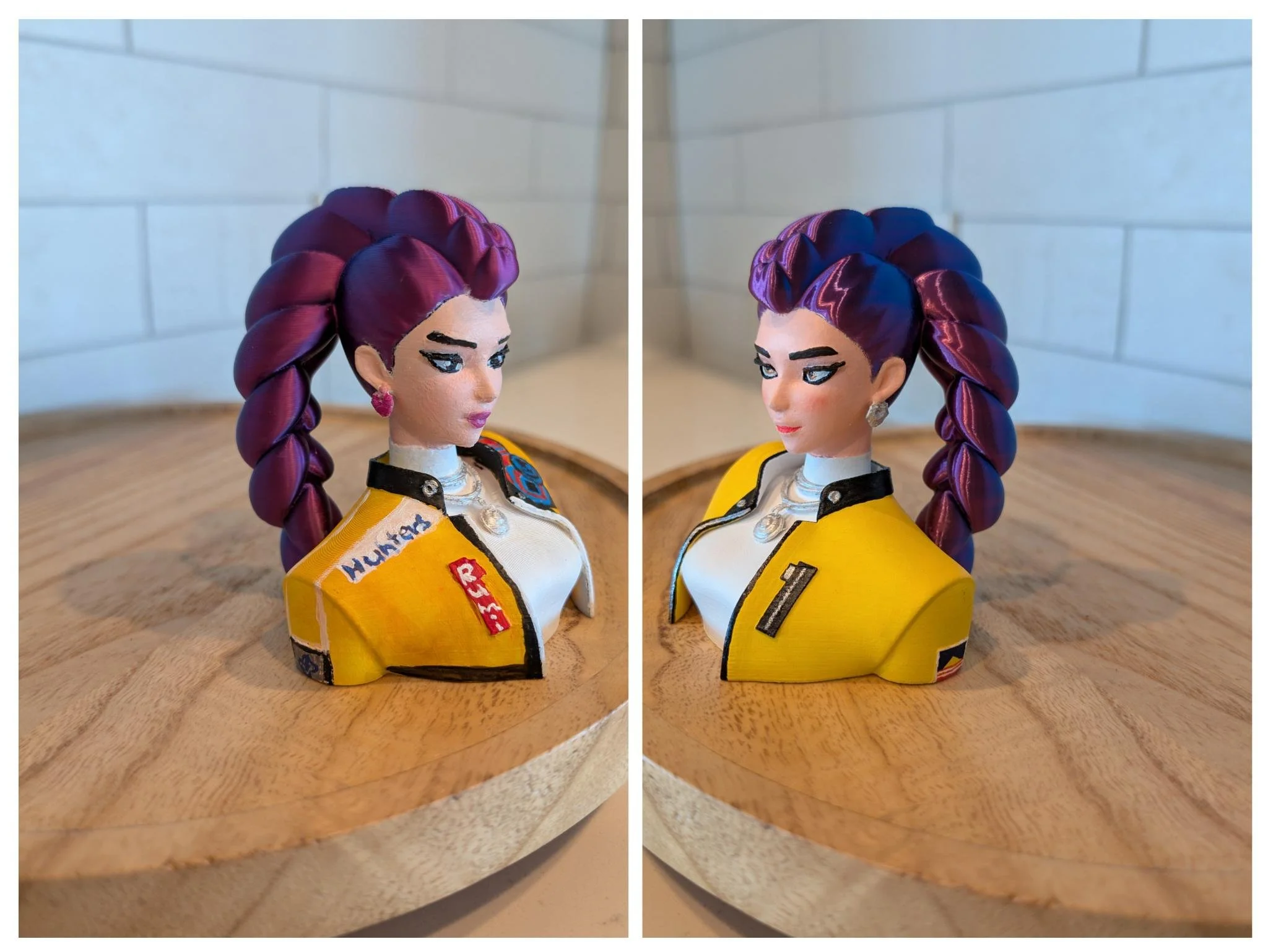 Two side-by-side photos of a doll with purple braided hair wearing a yellow racing suit with various patches, placed on a wooden surface against a white tiled background.