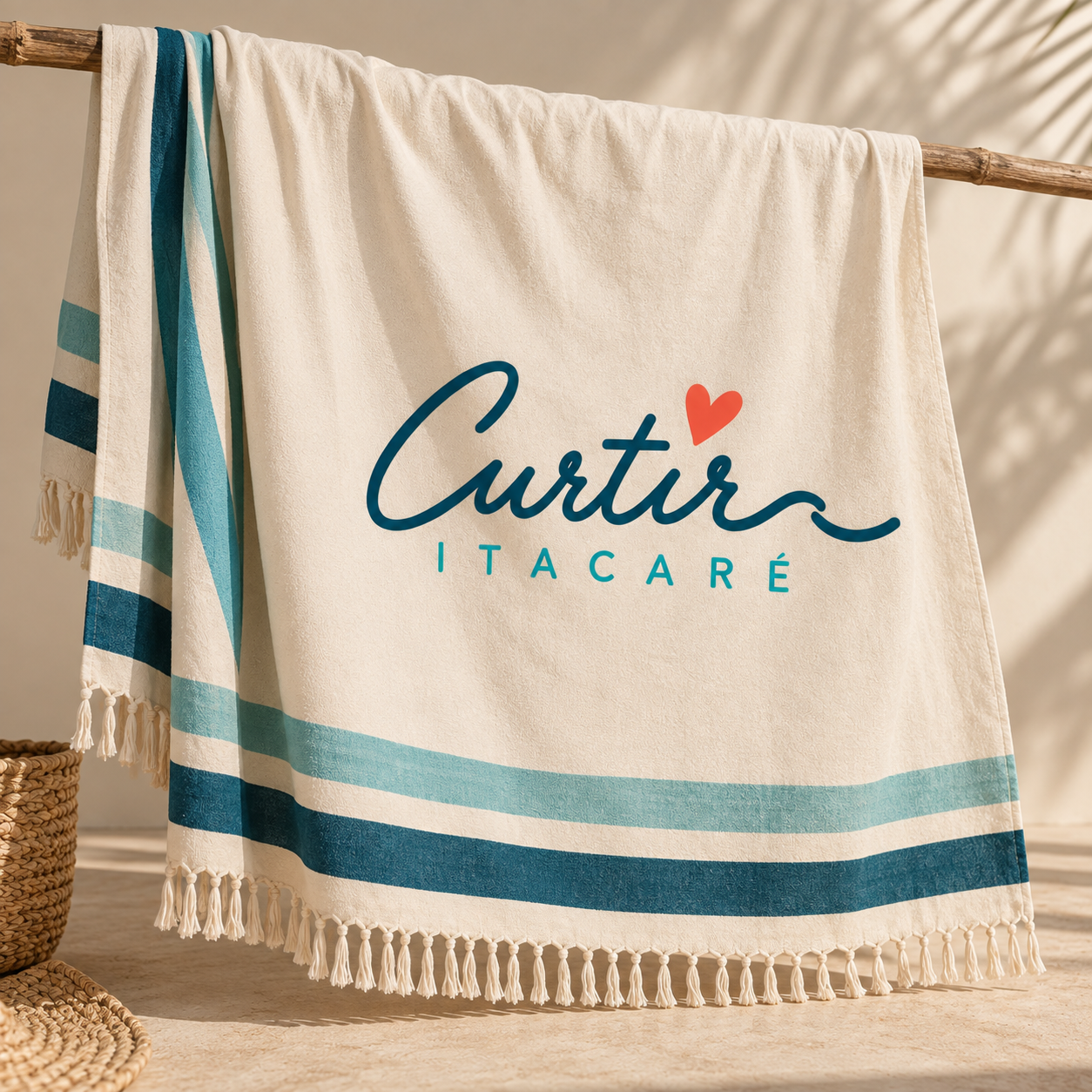Toalha de praia branca com listras azuis, exibindo o texto 'Curtir Itacaré' com um coração vermelho acima da letra 'i'.