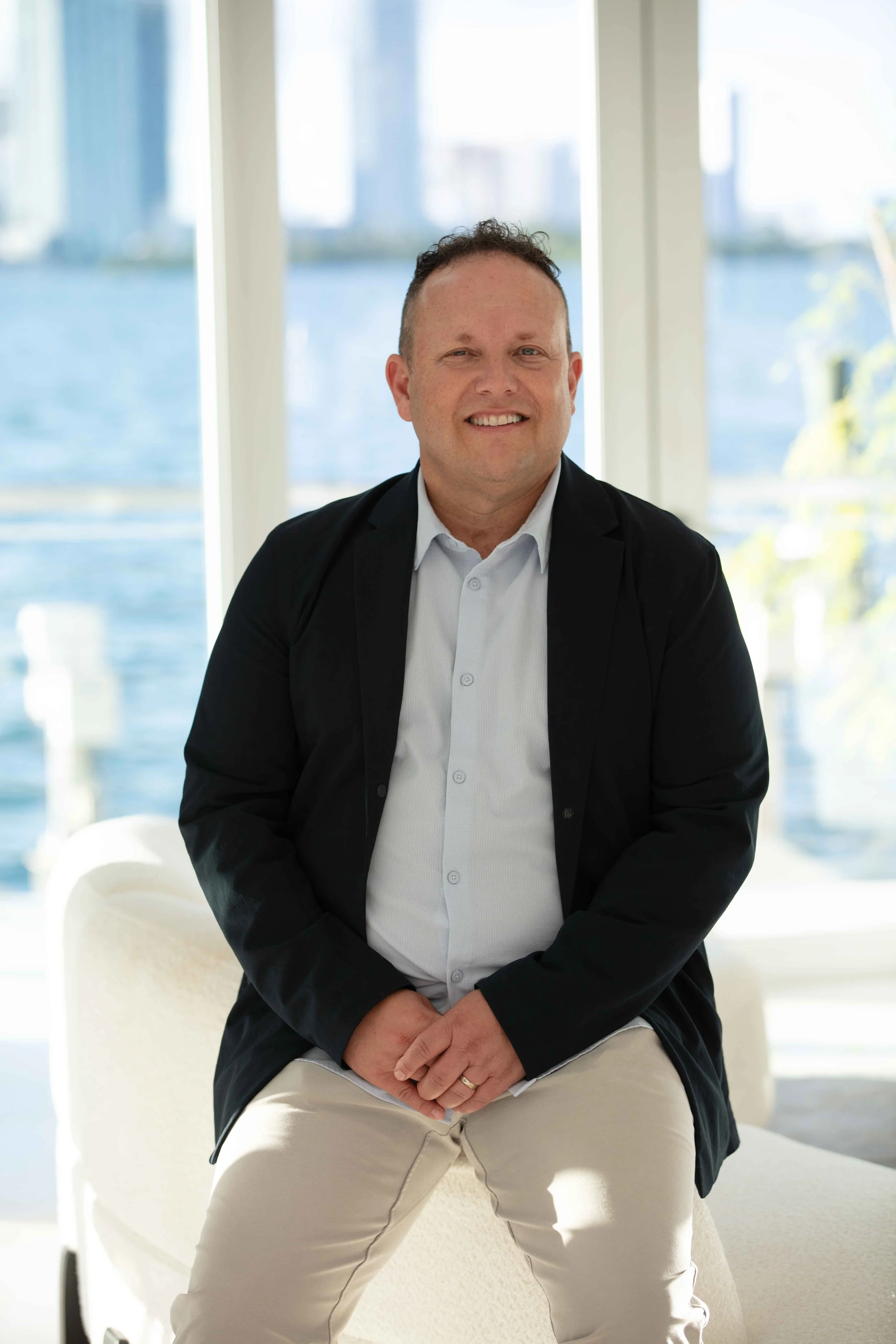 Avi Horowitz, real estate agent serving Boca Raton, seated and smiling