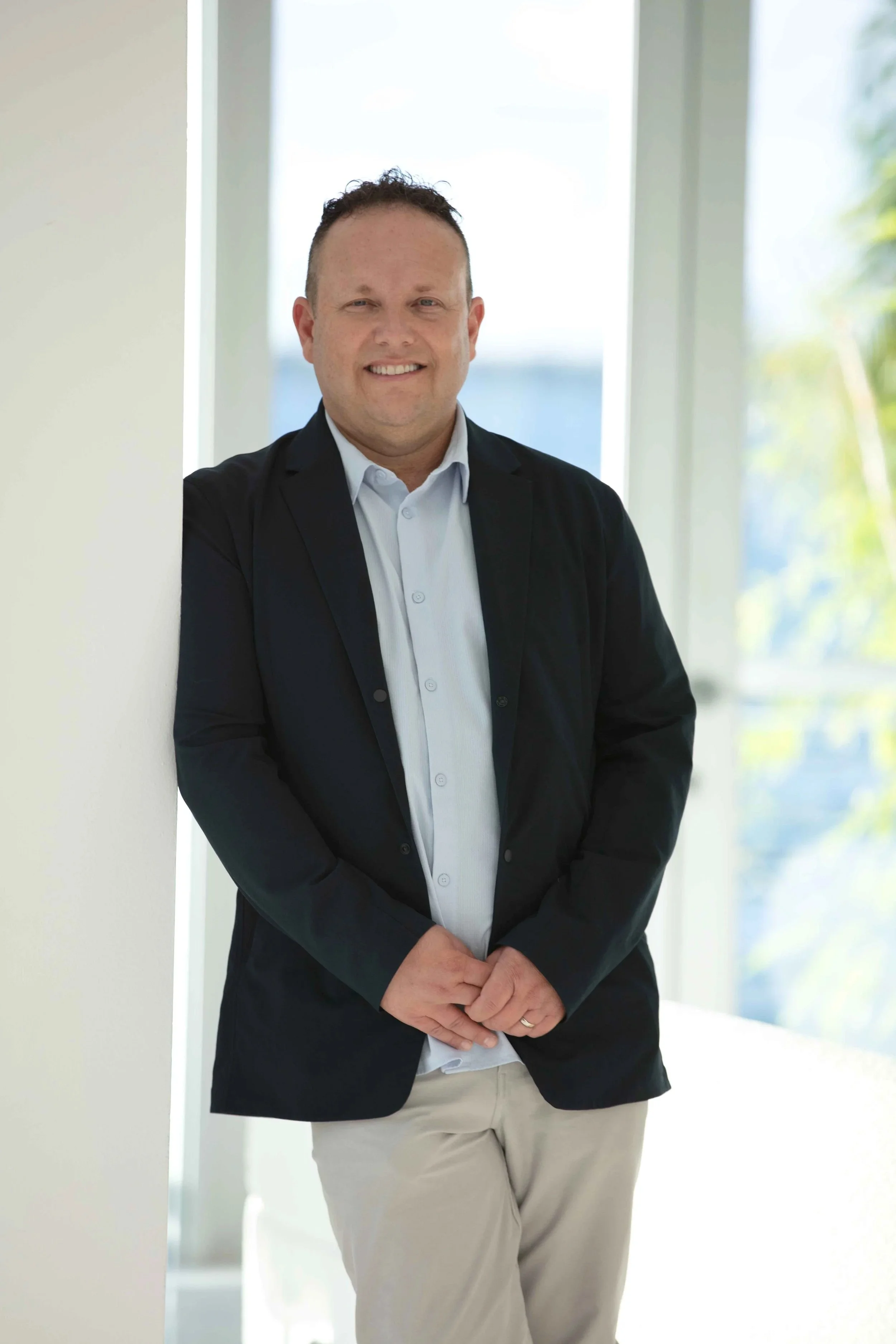 Avi Horowitz, real estate agent with RARE Real Estate, LLC, standing and smiling