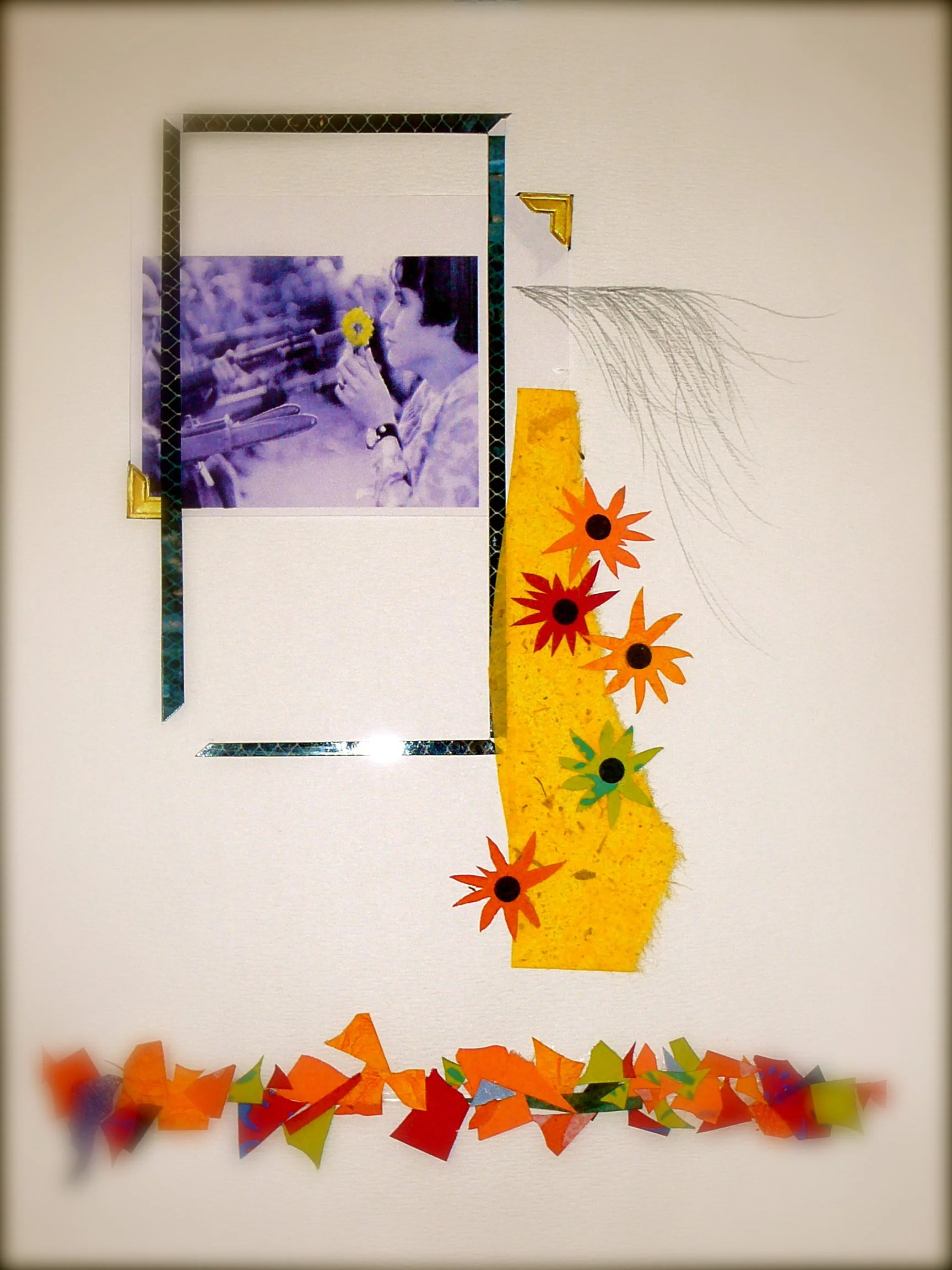 A decorated bulletin board with a purple-tinted black and white photo of a person holding a yellow flower, surrounded by layered borders, yellow and orange paper flowers, and multicolored confetti at the bottom.