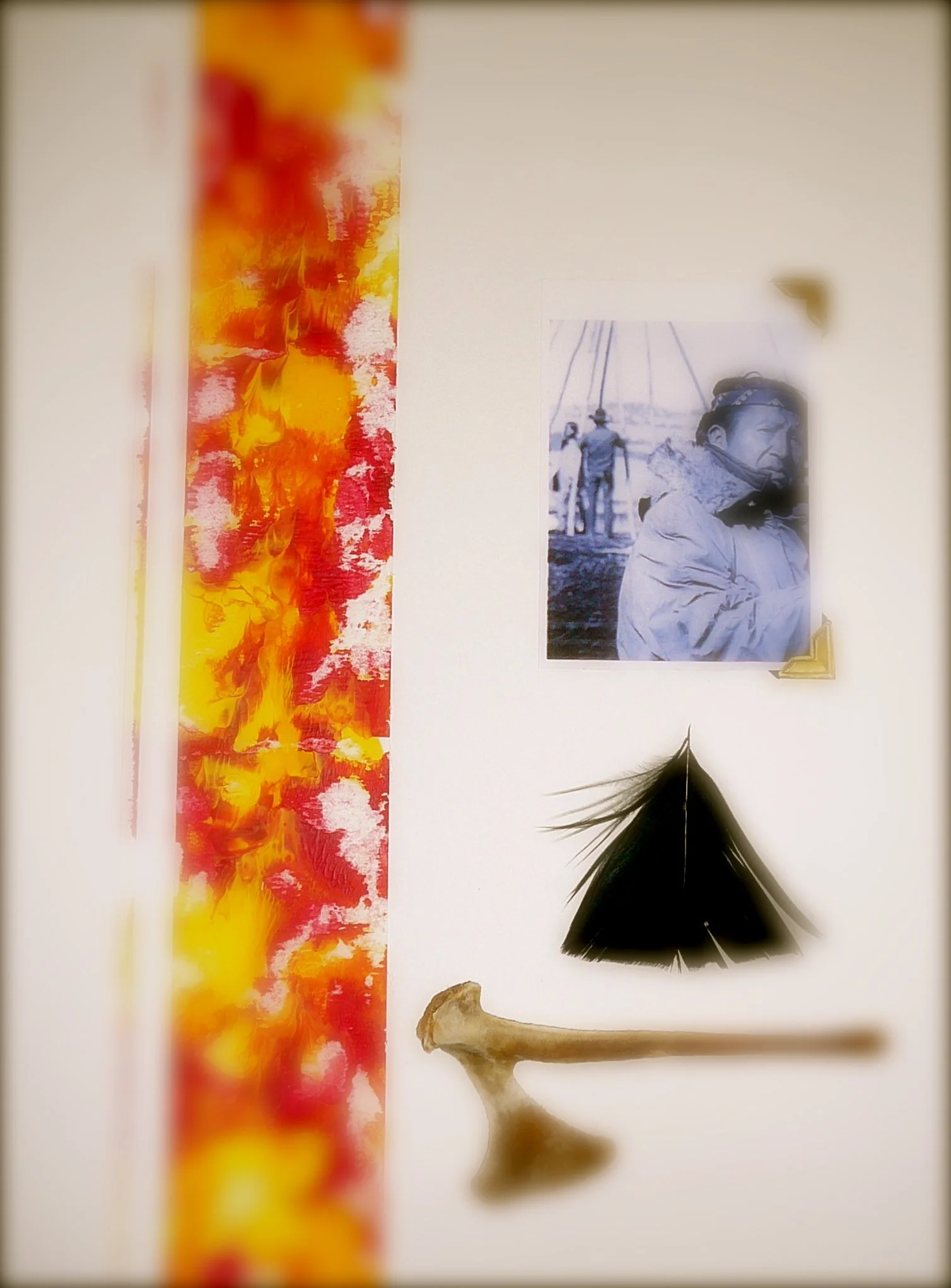 A vertical abstract painting with red, yellow, pink, and orange colors on the left side and a black feather, a small bone, and a black-and-white photo of a person on the right side.