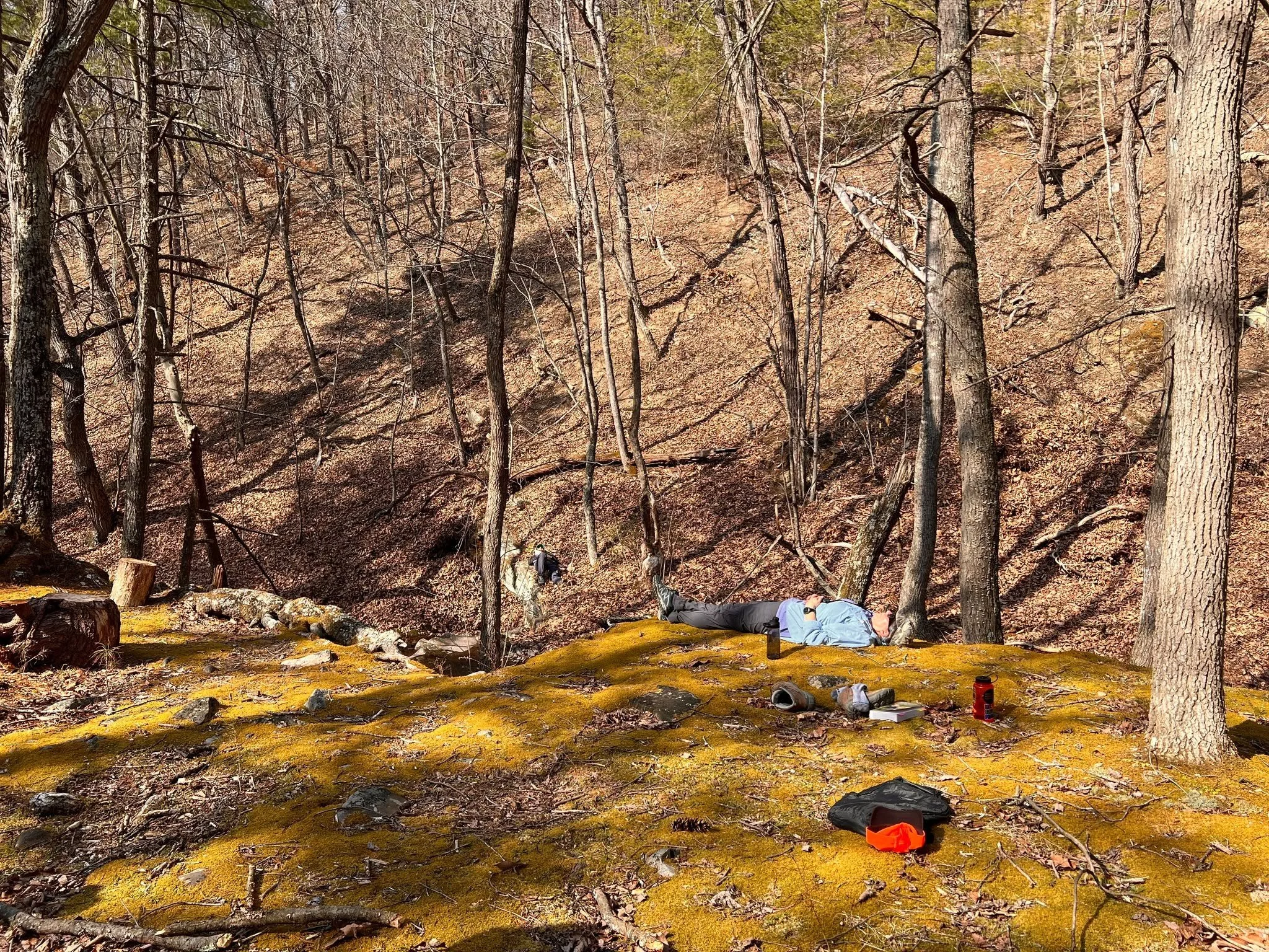 An attendee rests at the waterfalls during the spring 2025 retreat.