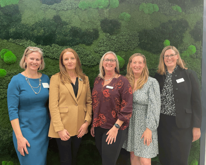 five women smiling at the camera