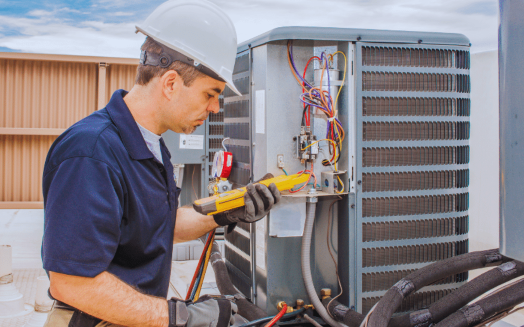 Technician wearing safety gear repairing an HVAC unit with a multimeter