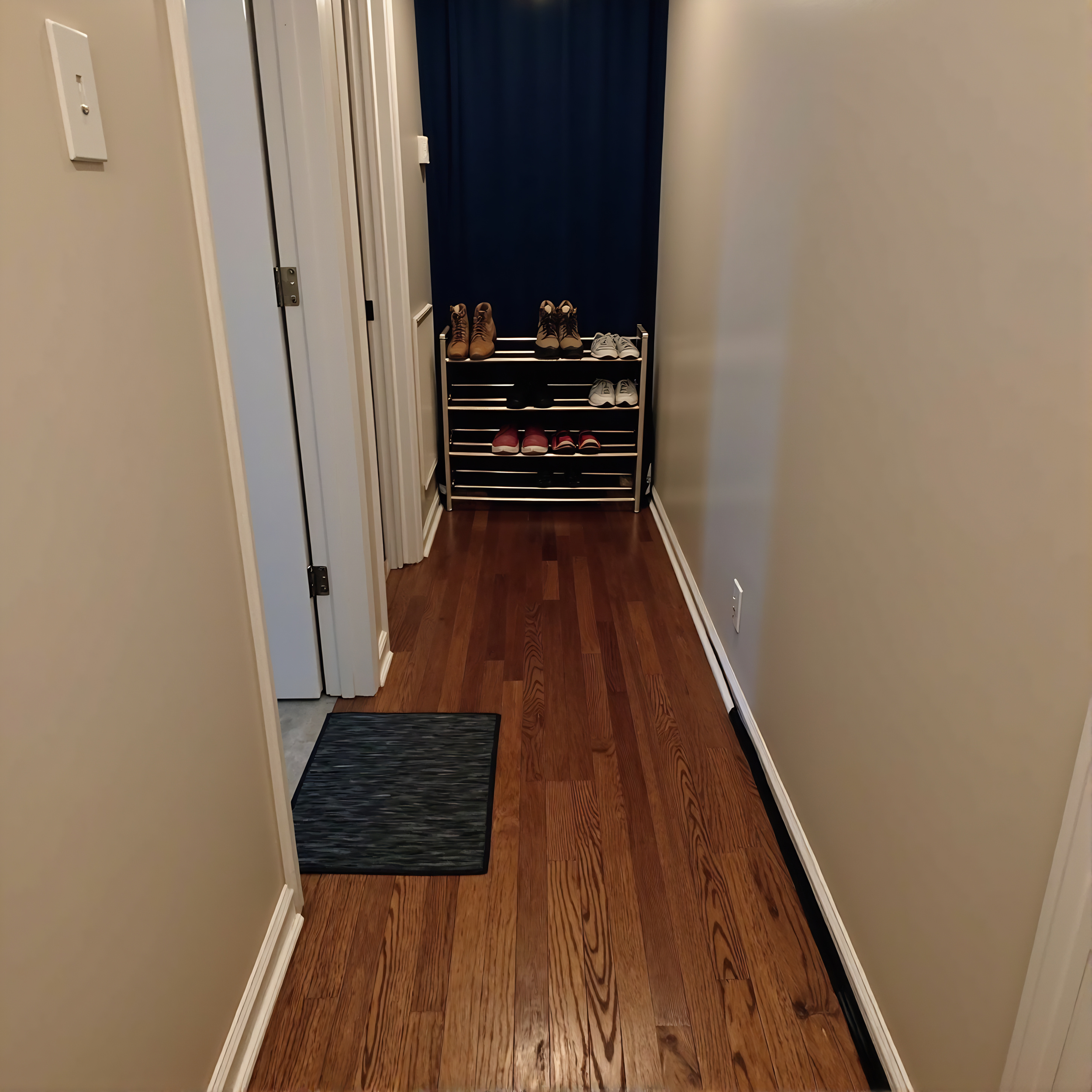 Private hallway with suite, bath, and utility room. 