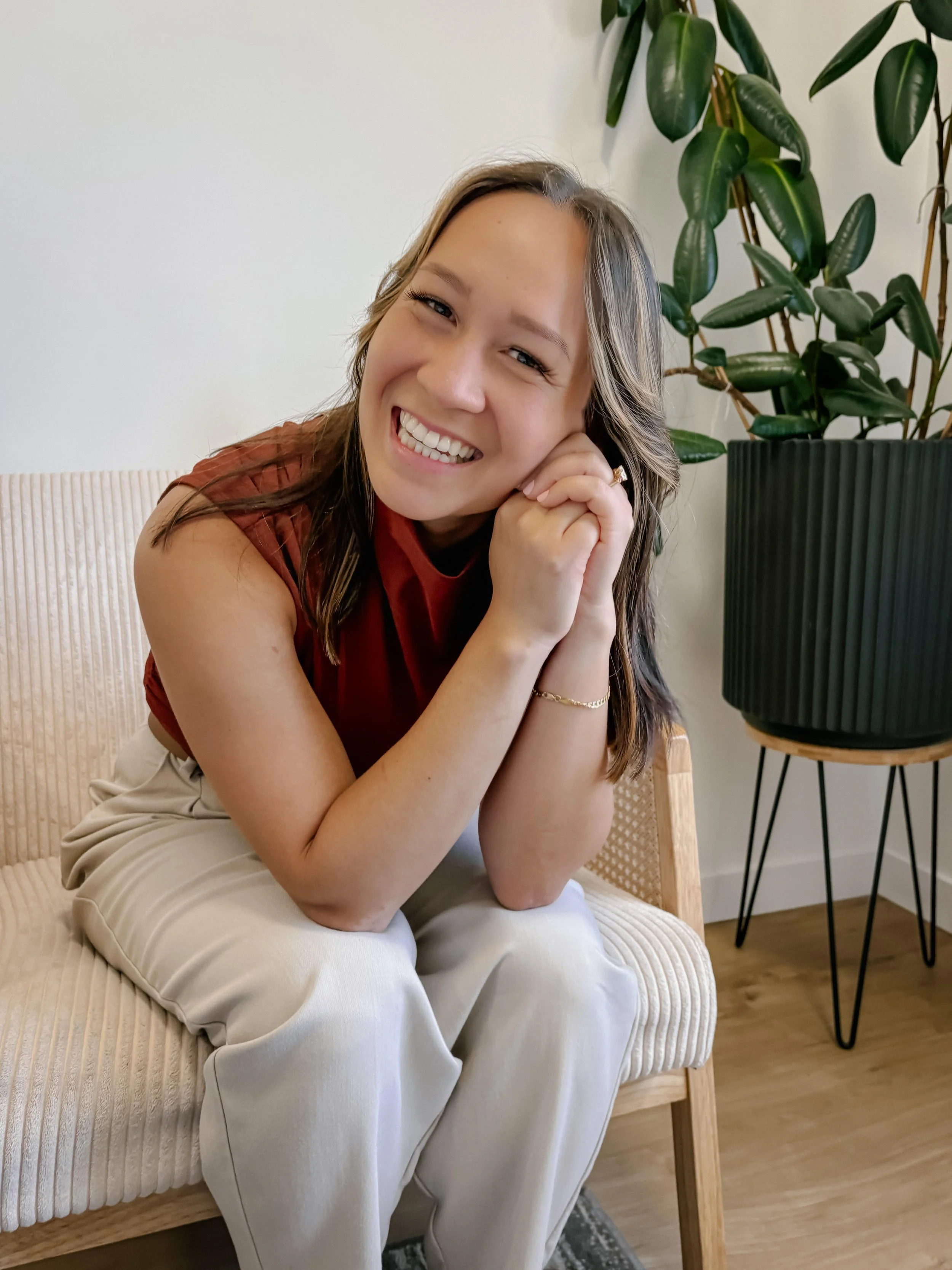 Dr. Sydney Lake ND sitting and smiling in a Victoria BC clinic.