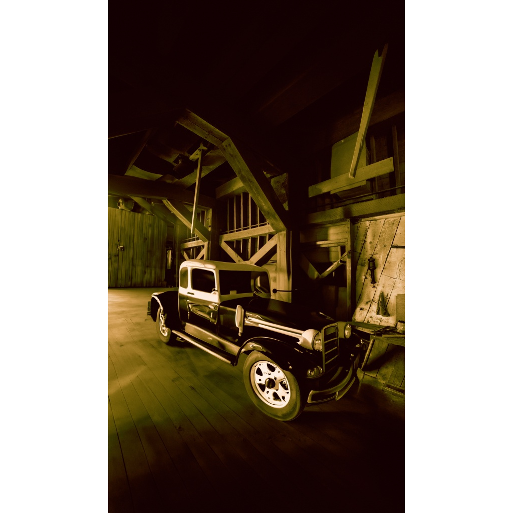 Vintage truck parked inside a weathered wooden barn near Bozeman, Montana, photographed by Tom Lance.