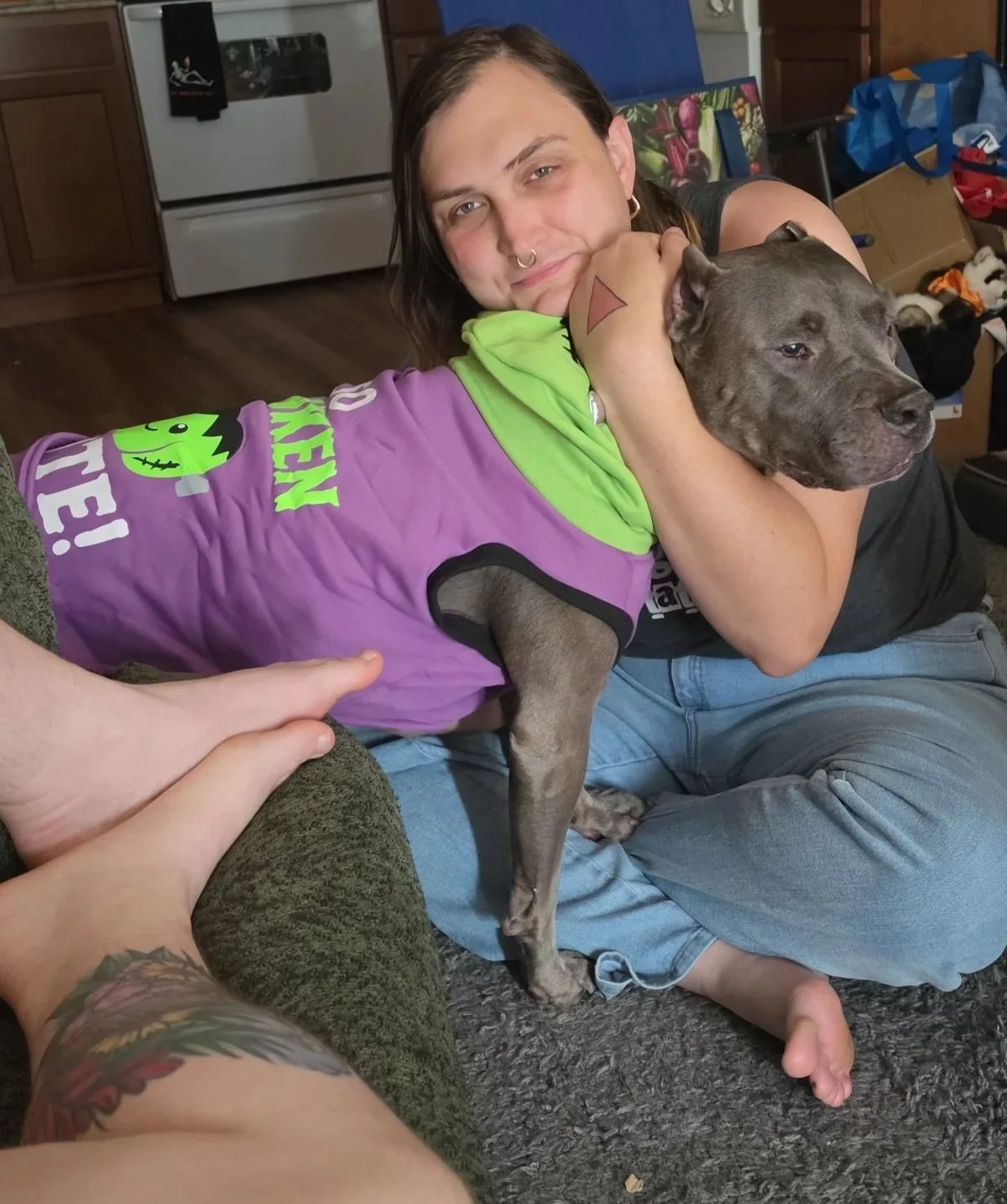 Crybaby Angell, a Colorado tattoo artist's girlfriend posing with his dog, Prince.