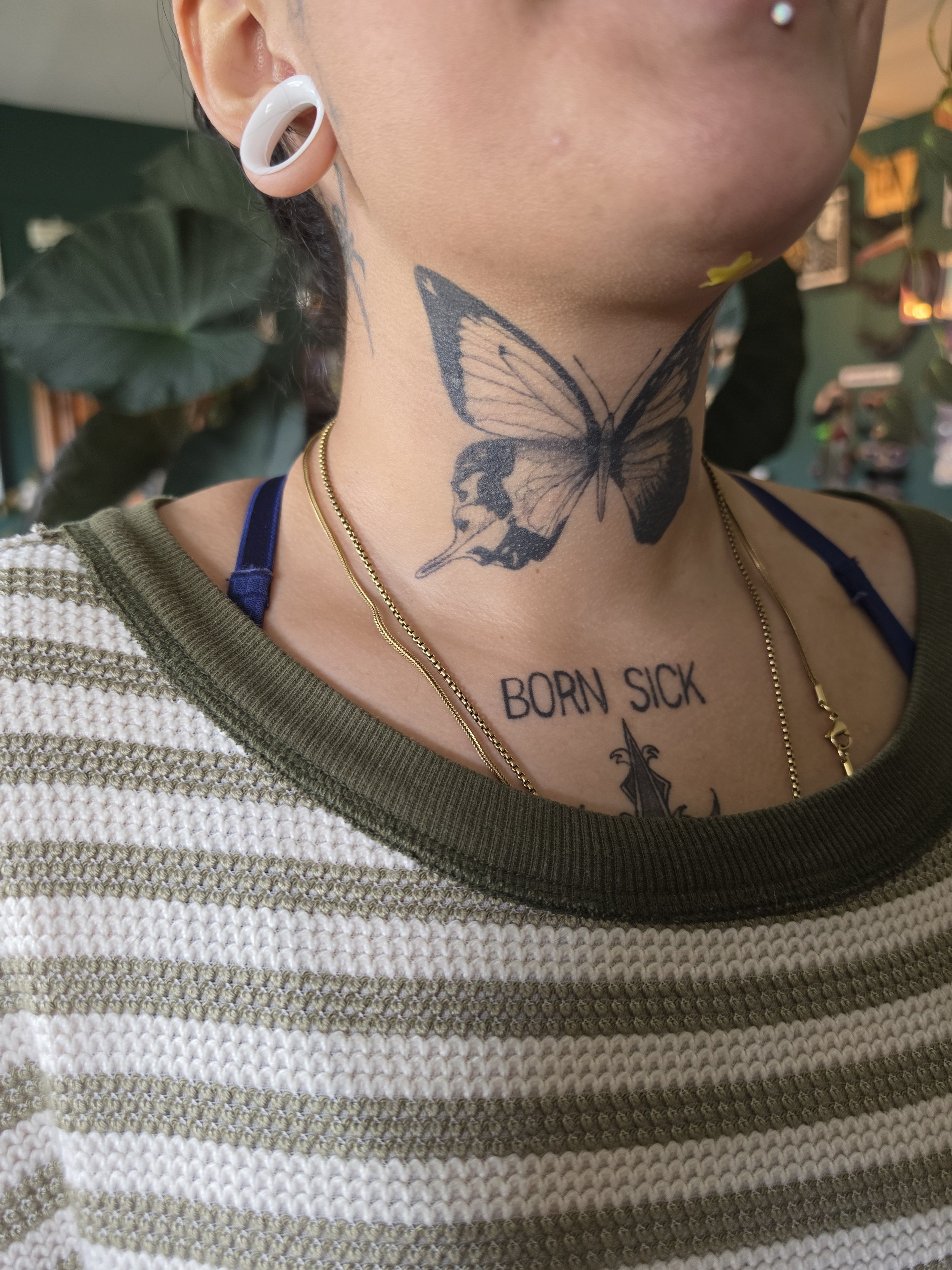Crybaby Angell, a Colorado tattoo artist tattooed a Chimera butterfly on a neck.