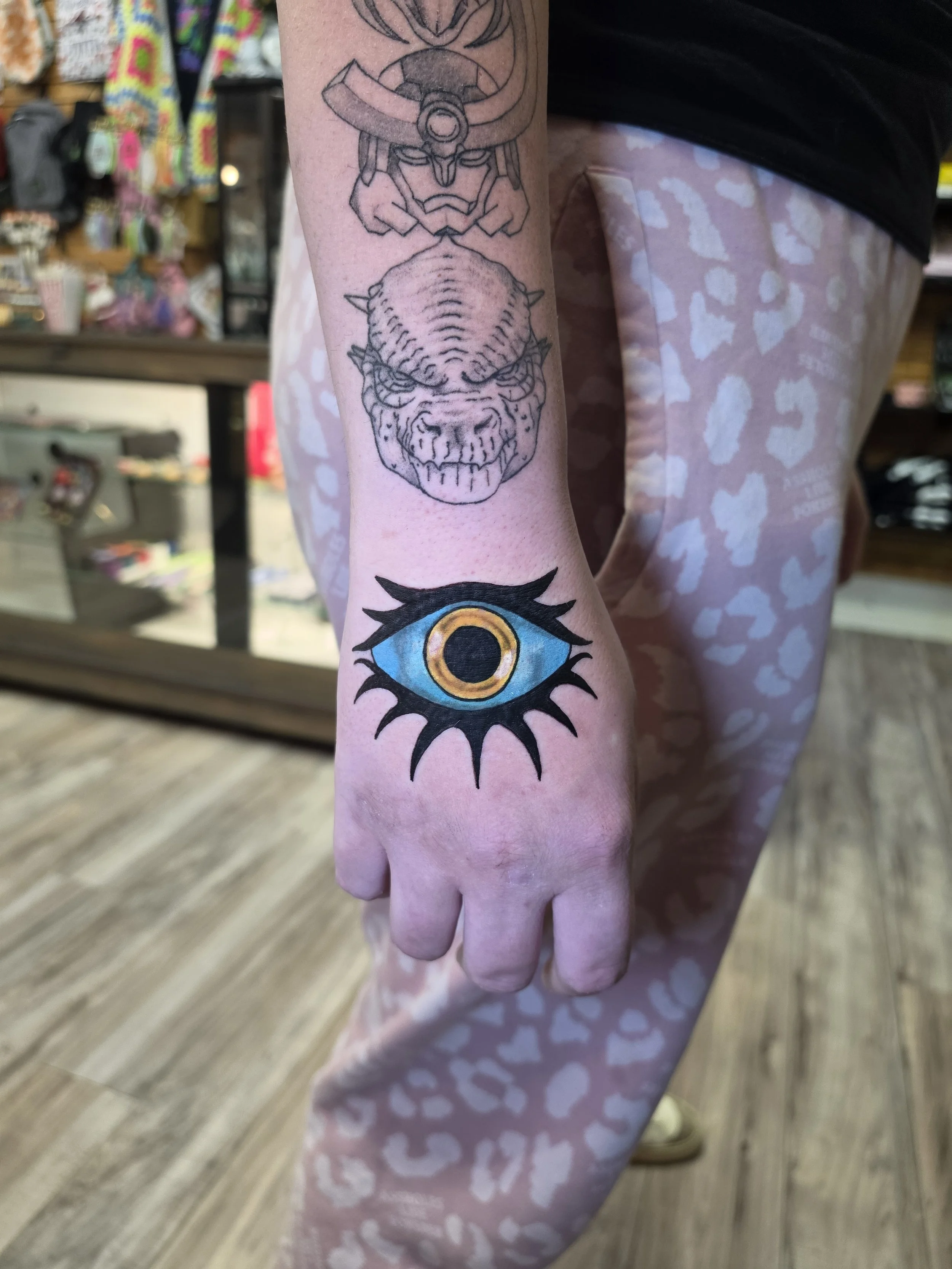 Crybaby Angell, a Colorado tattoo artist tattooed a big bold blue eye on the hand.
