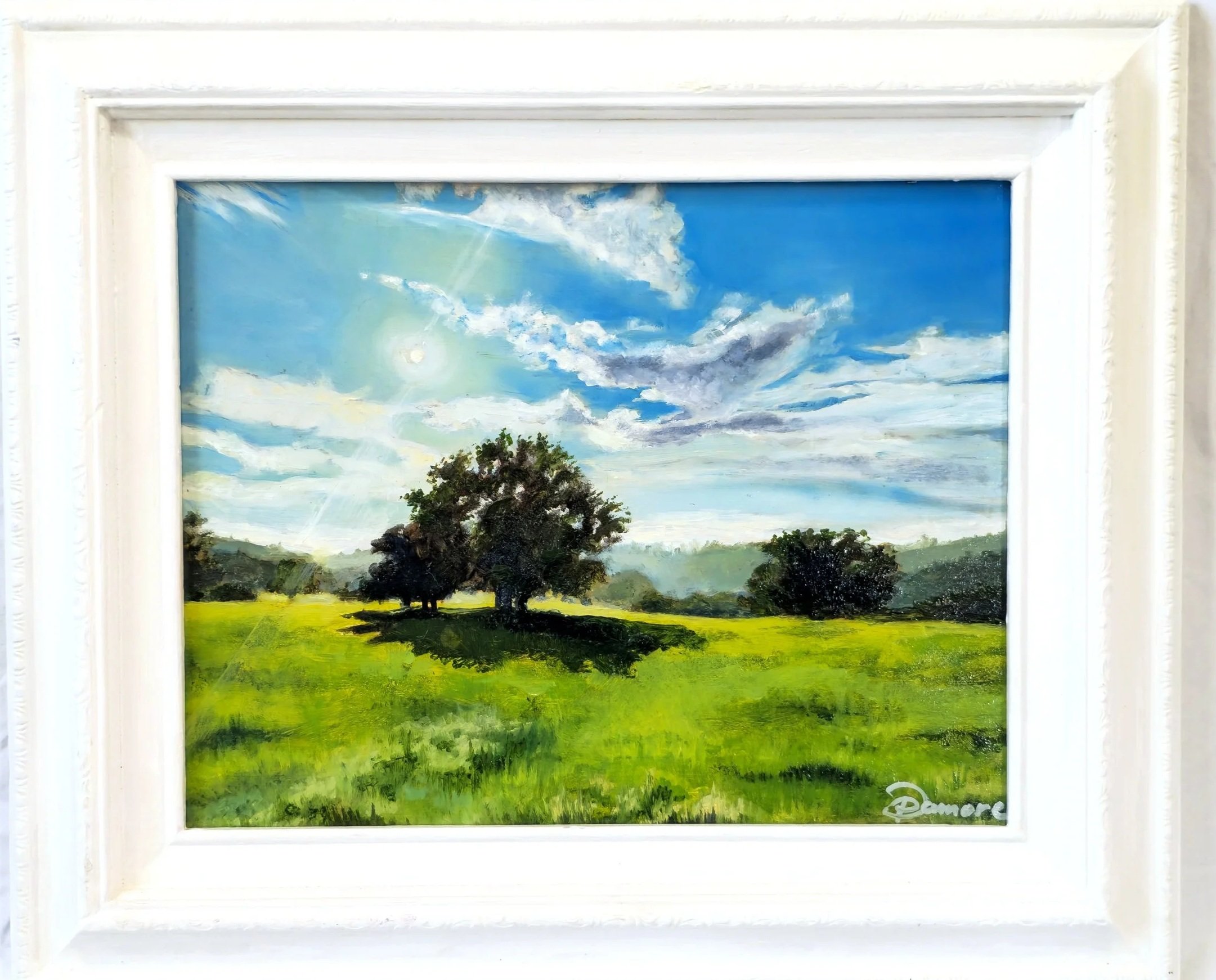 Landscape painting of a green field with trees under a blue sky with white clouds.
