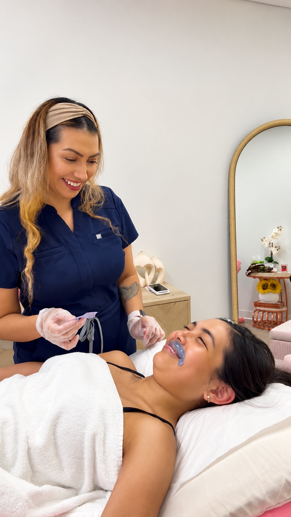 Client receiving a professional lip wax from licensed esthetician Caty Lee at Mi Piel Beauty Bar in Beltsville, MD.