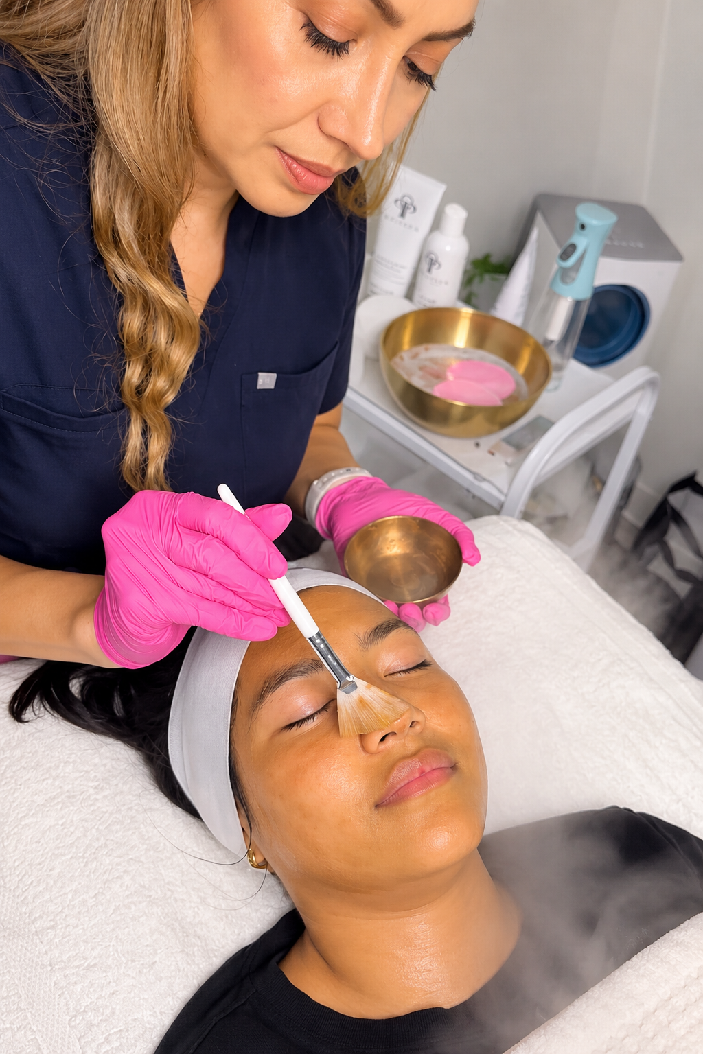 Licensed esthetician Caty Lee applying an exfoliating treatment during a customized facial at Mi Piel Beauty Bar in Beltsville, MD.