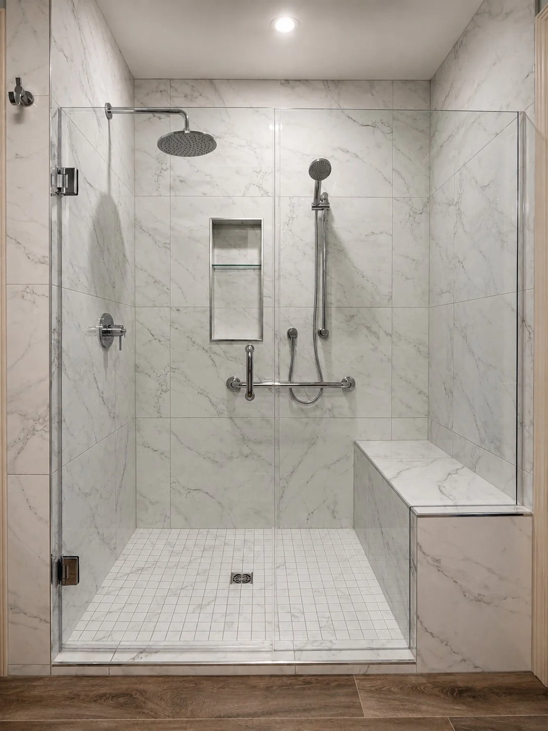 Frameless marble-look shower with tiled bench