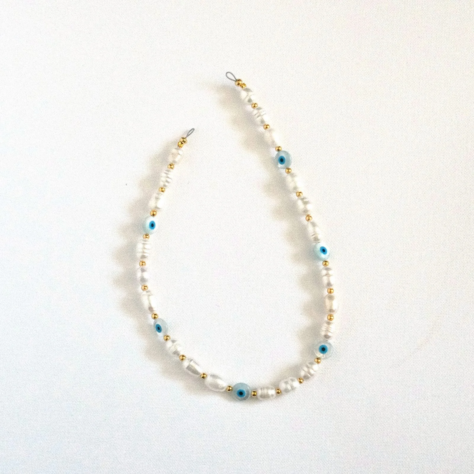the watchful — beaded phone charm