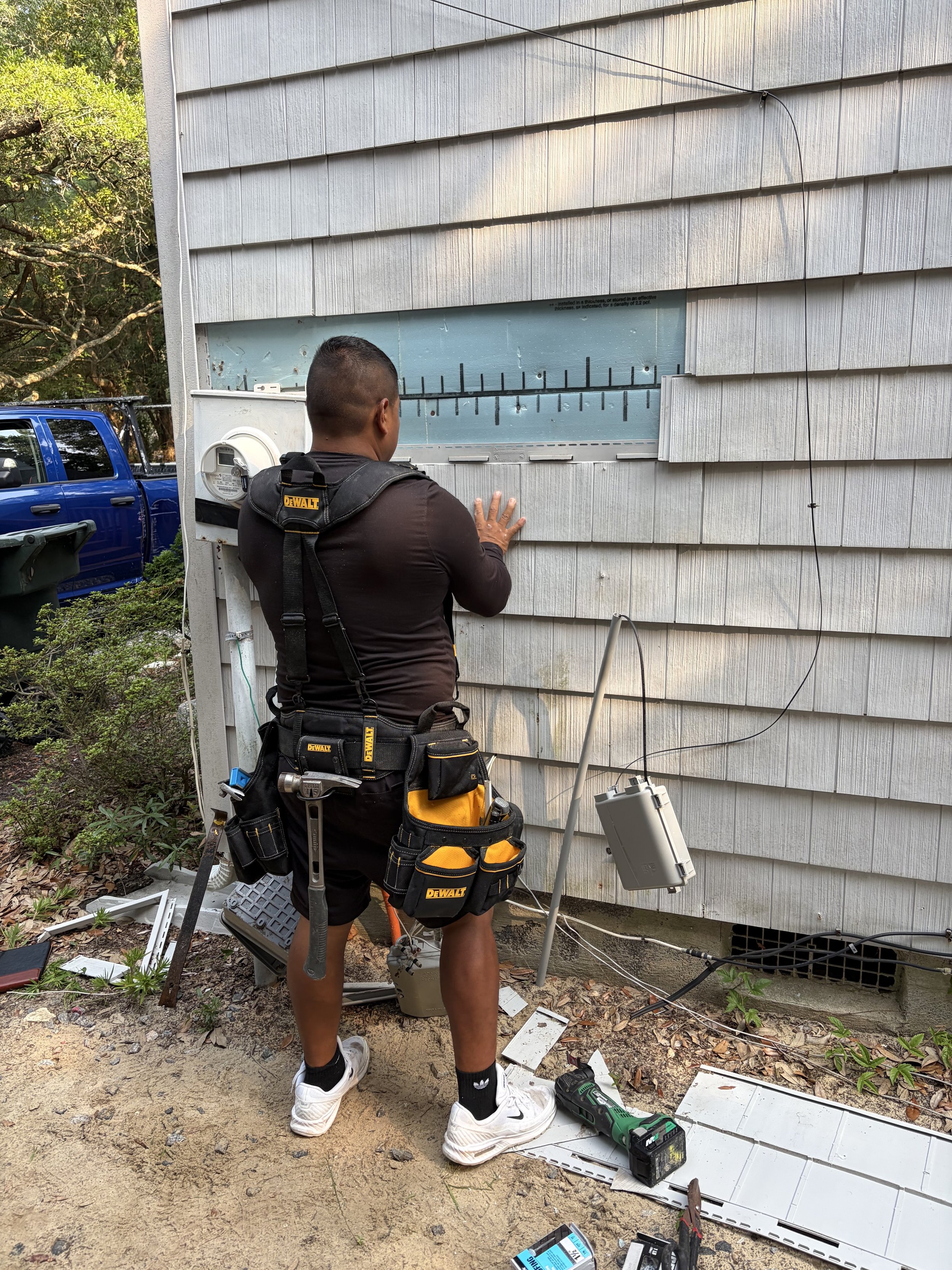 Alpha Exteriors crew replacing siding on an Outer Banks home.