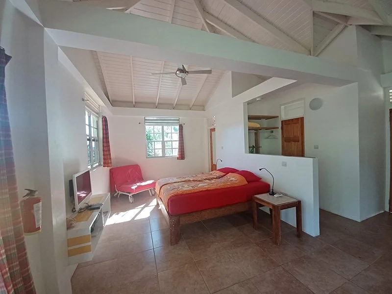 View of the bedroom area in the Ocean View Studio at Mango Garden Cottages