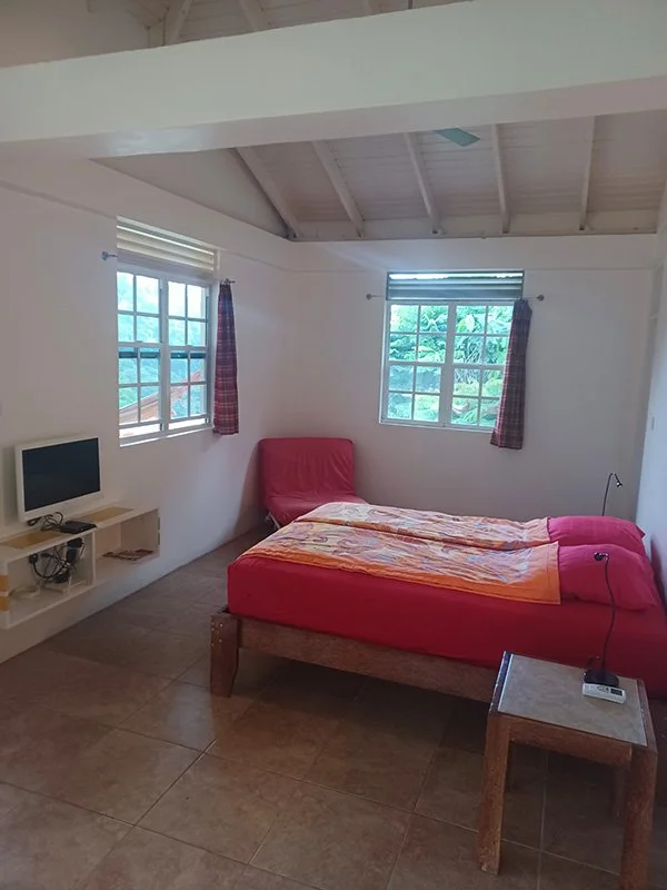 View of the queen-sized bed in the bedroom area of the Ocean View Studio