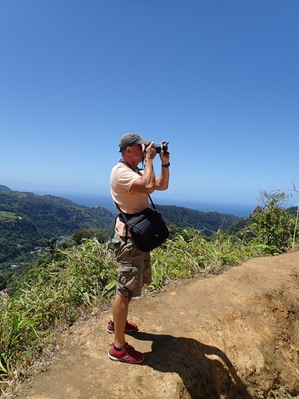 One of our guests, on one of Eddison's tours, taking photos at the top of Dominica, looking towards Les Saintes and Guadeloupe (the next big islands north of us)