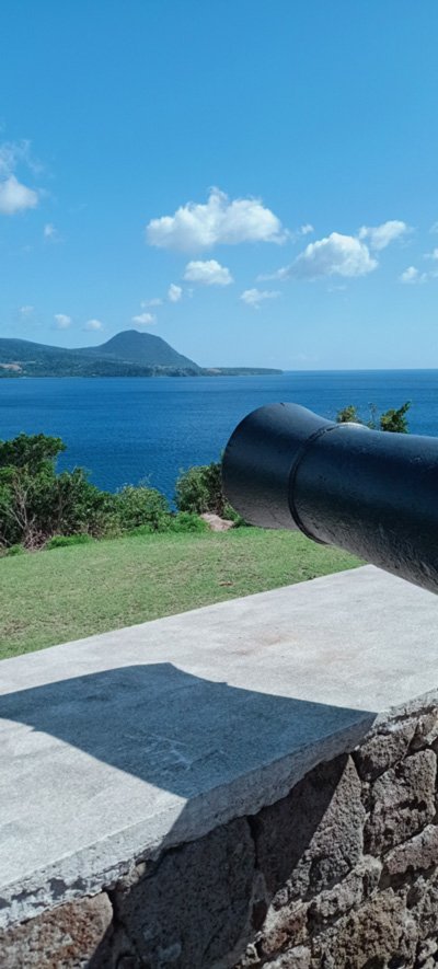 One of the cannons at Fort Shirley, looking down the Dominican coast, across Prince Rupert Bay