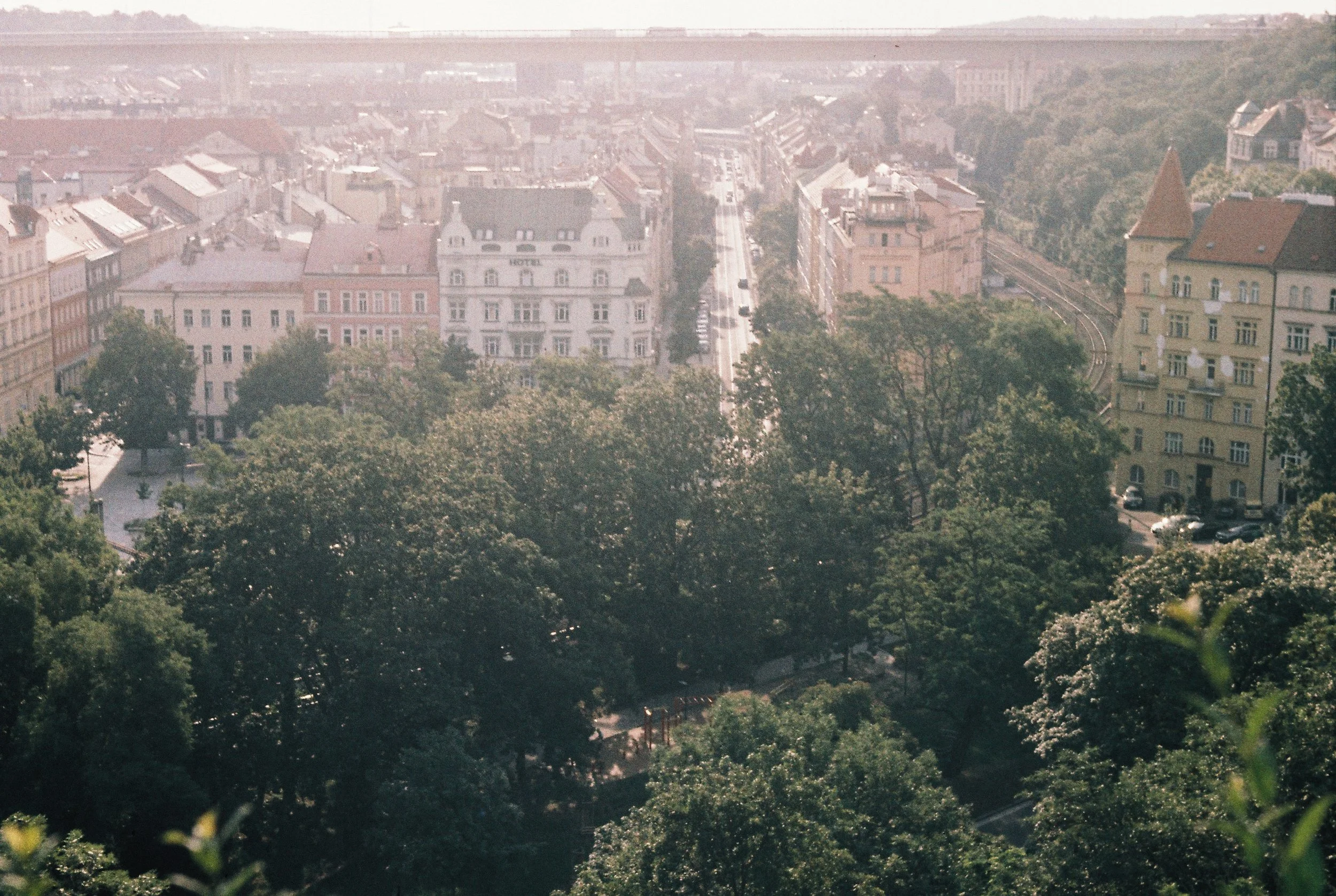  This one I remember: I took it at Vyšehrad. That spot gives you a great view over Prague and the Nusle Bridge, and the row of charming European houses bathed in sunlight came out beautifully against the city in the background. I really love the laye