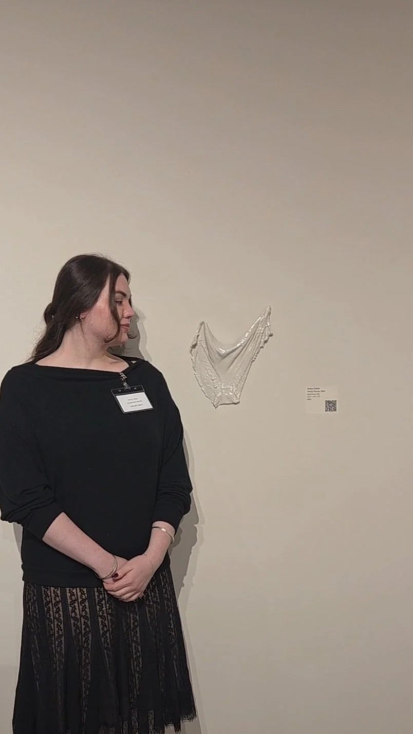Railey standing with her peice Panty Patent in the Materials Hard+Soft Exhibition in 2026.