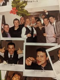Group of people celebrating at a party with one person holding a glass, and a close-up of a smiling woman in the foreground.