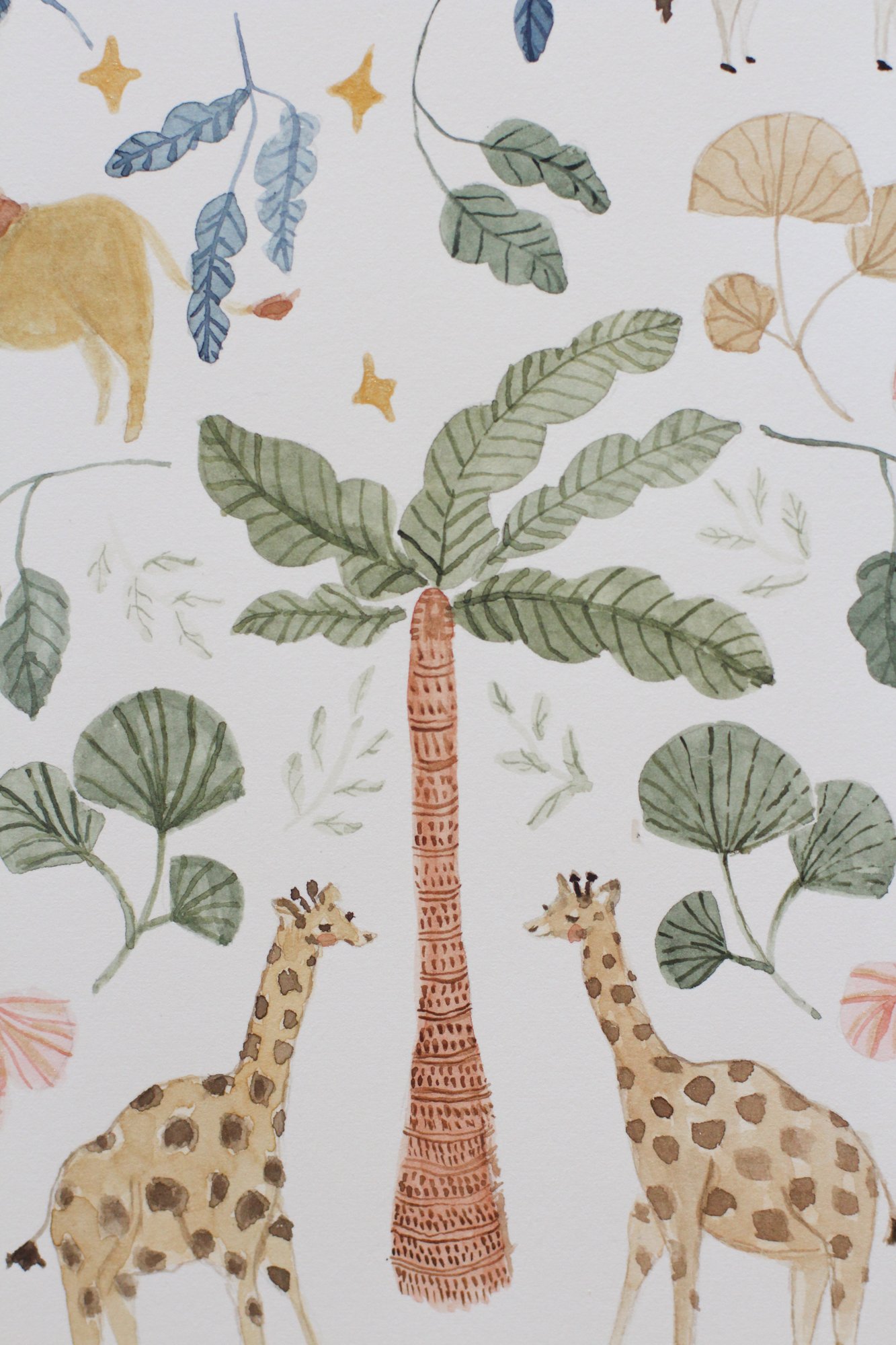 Watercolor illustration of three giraffes standing under a tall palm tree with large green leaves. Two giraffes have a typical giraffe pattern, and the third is mostly obscured. The scene includes small yellow stars and faint leaves in the background