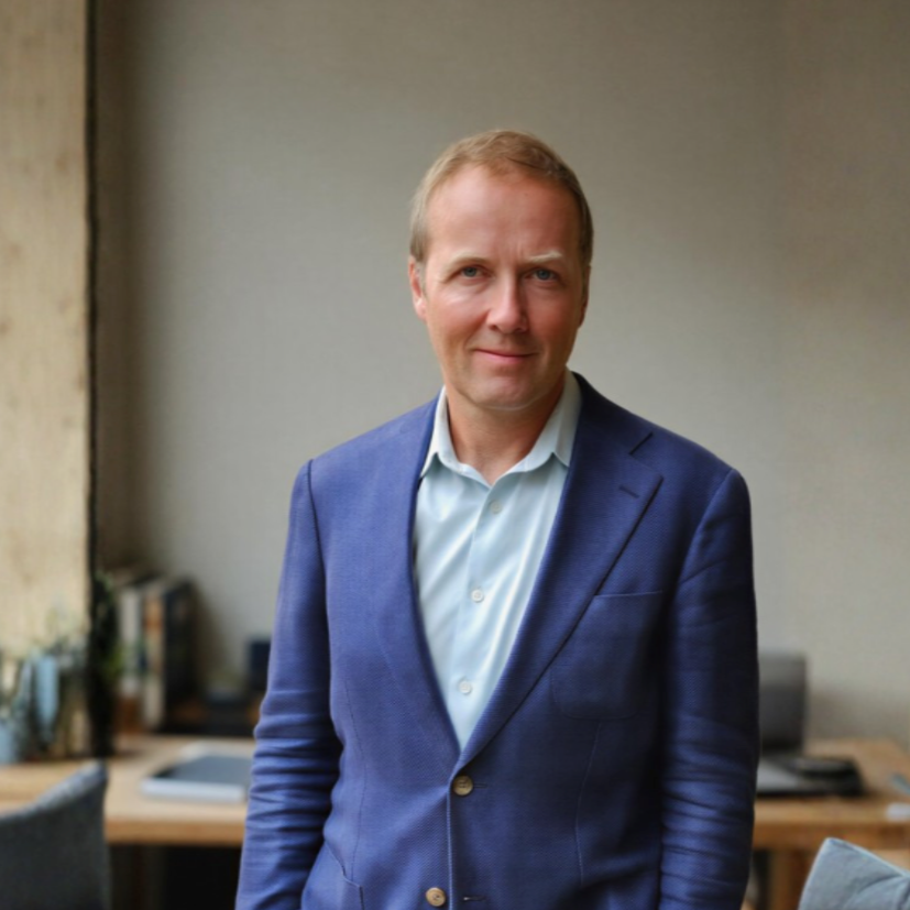 James Fenner, founder of Gryphon Advisory, standing in a professional office setting.