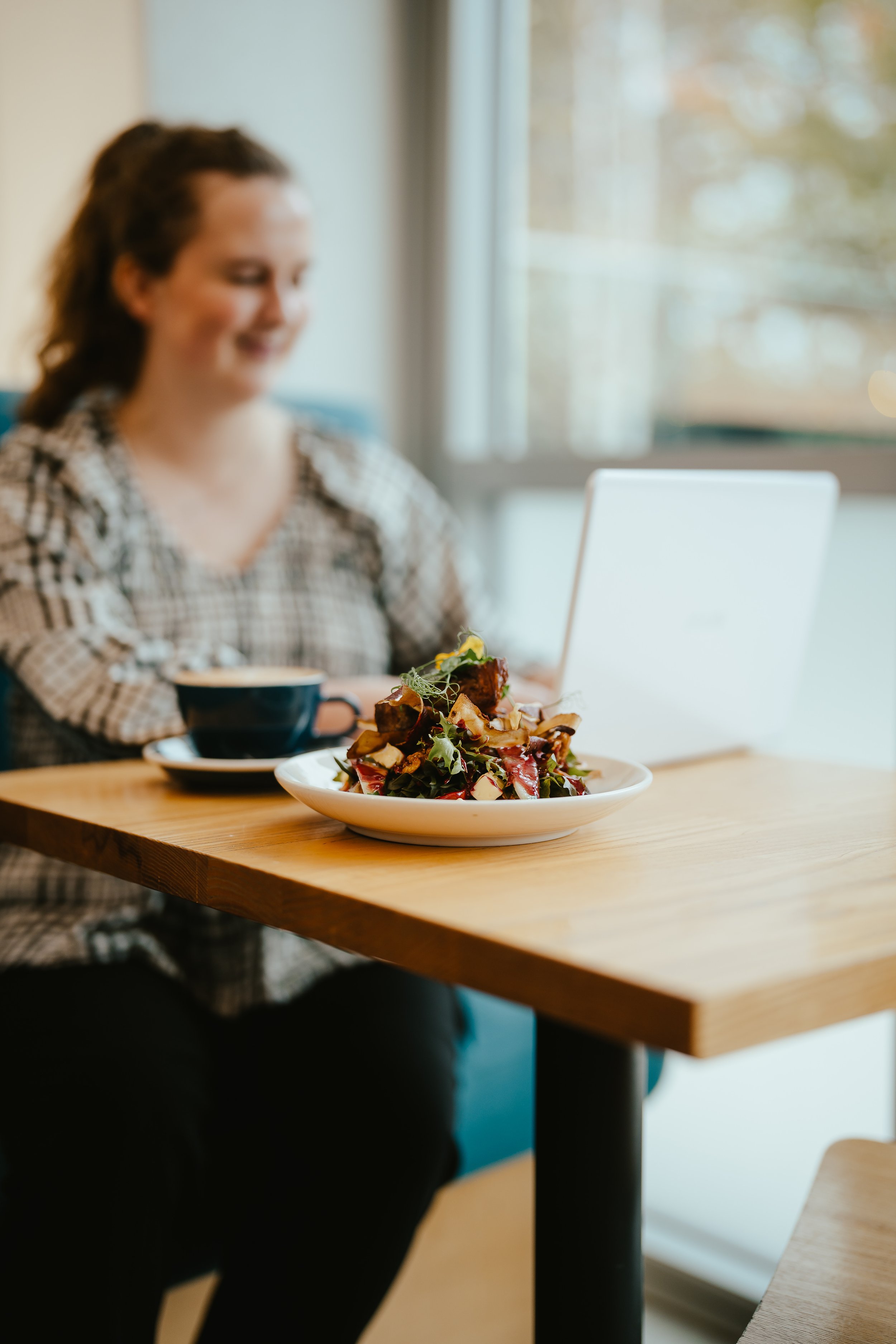 A customer enjoying a cosy corner booth at LOCAL Cafe & Eatery