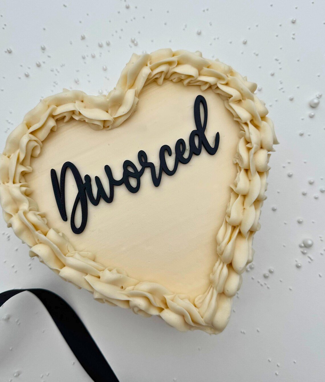heart shaped cake with a cake topper reading 'divorced'