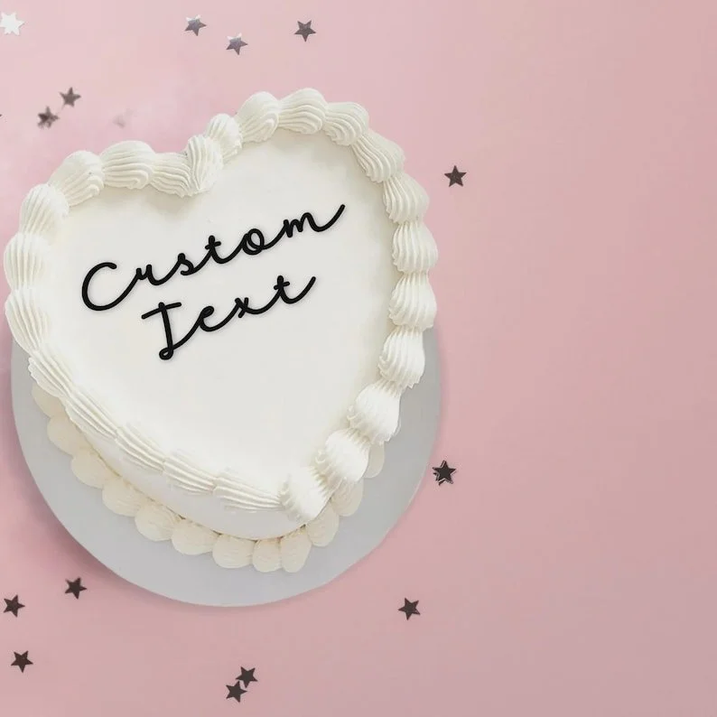 heart shaped cake with a custom text cake topper