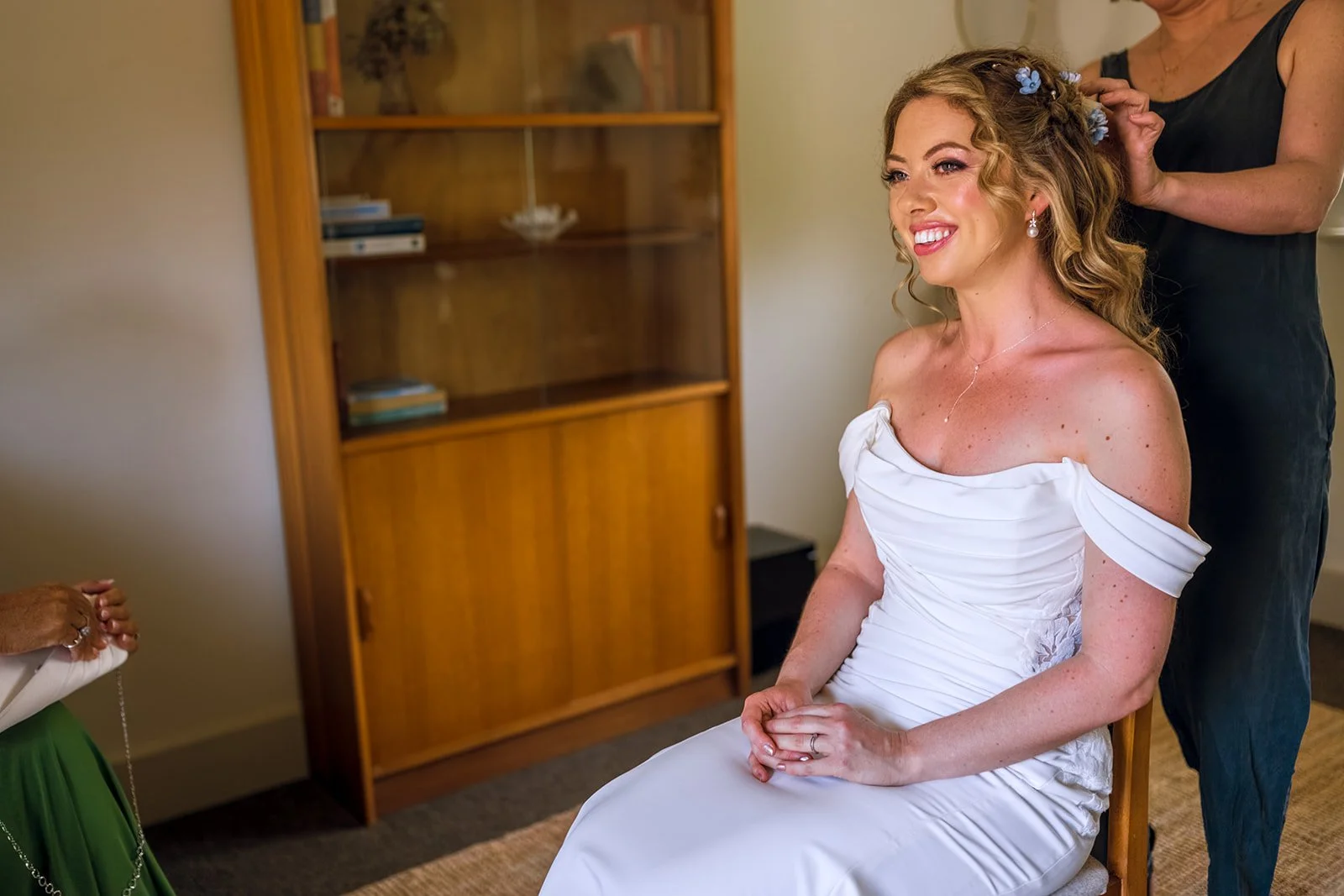 Claire Field Bridal Hair and Make up. A bride having her hair finished.